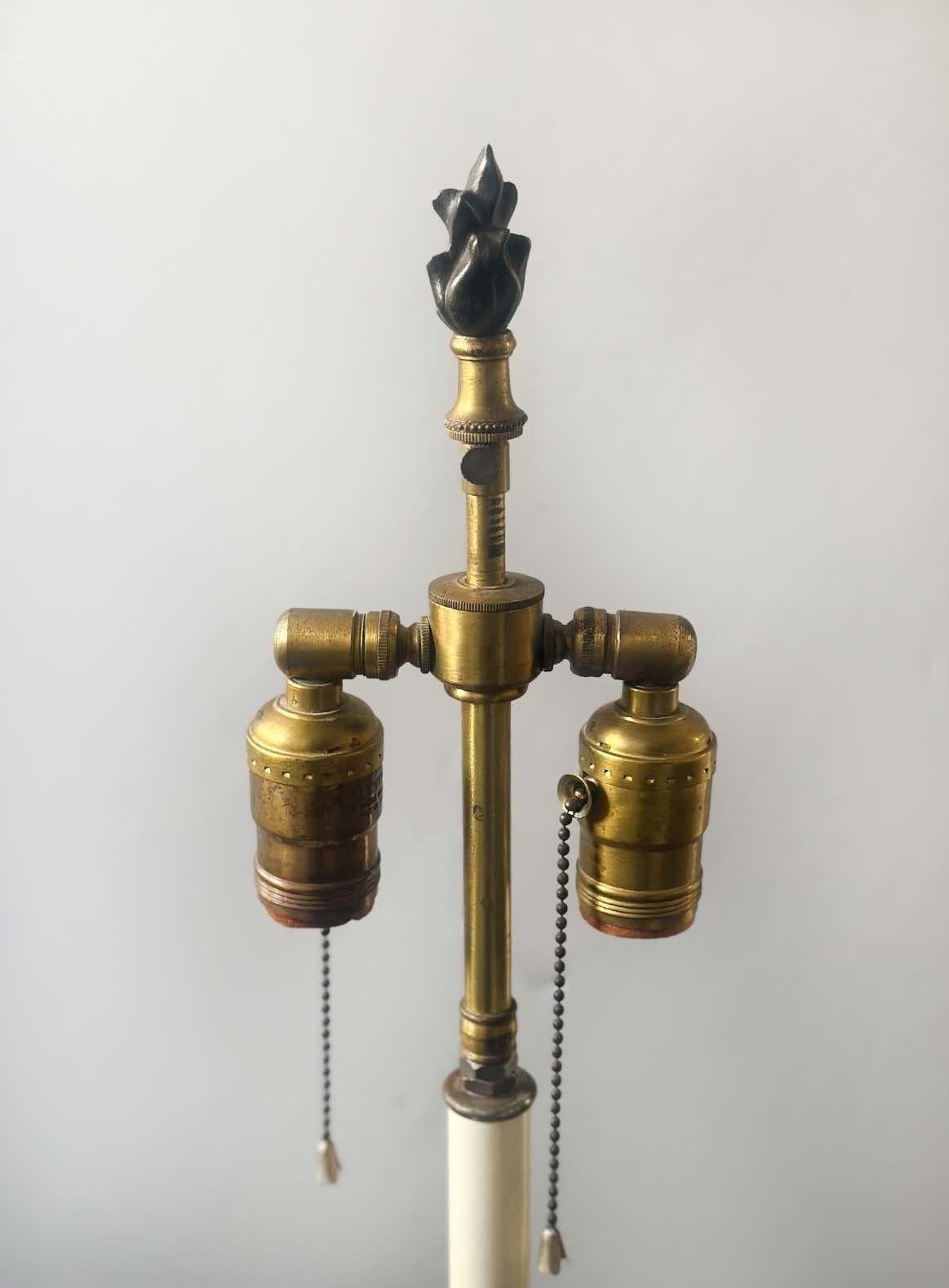 Pair of French 19th Century Empire Style bronze candelabras converted to table lamps, having D'ore bronze and dark patina. They are decorated with ornate foliate details and include footed bases.
*Rewired to fit US lighting