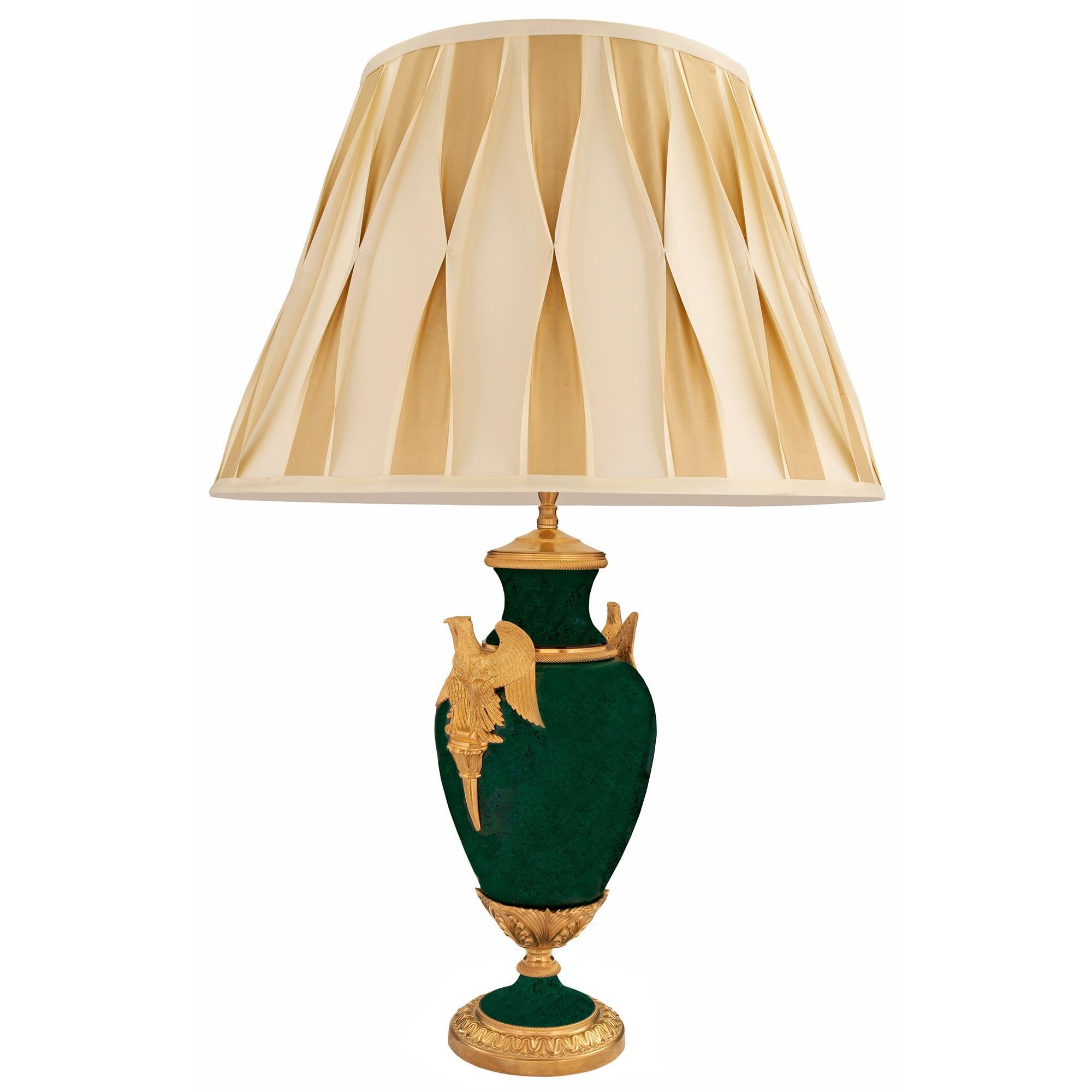 Una splendida coppia di lampade in porcellana e ormolu in stile Impero del XIX secolo. Ogni elegante lampada è sollevata da una raffinata base circolare in ormù con un motivo avvolgente in ormù. Il piedistallo a socle mostra un bellissimo disegno a