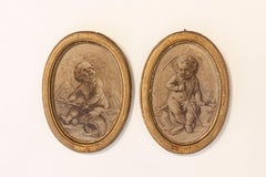 Paire de peintures grisaille ovales encadrées du 19ème siècle représentant deux putti