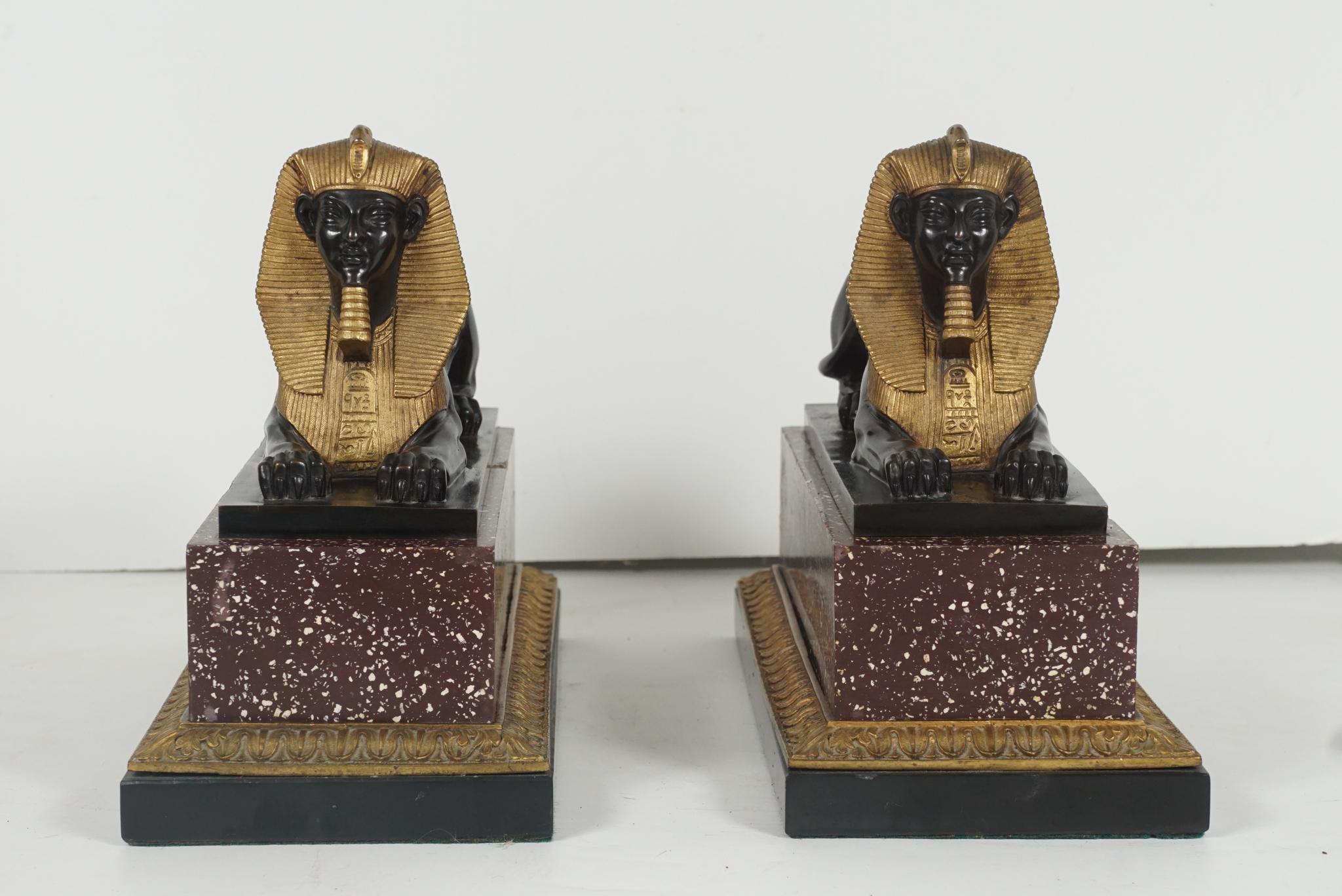 Cast Pair of French 19th Century Gilt & Patinated Bronze Sphinxes on Porphyry & Bron For Sale