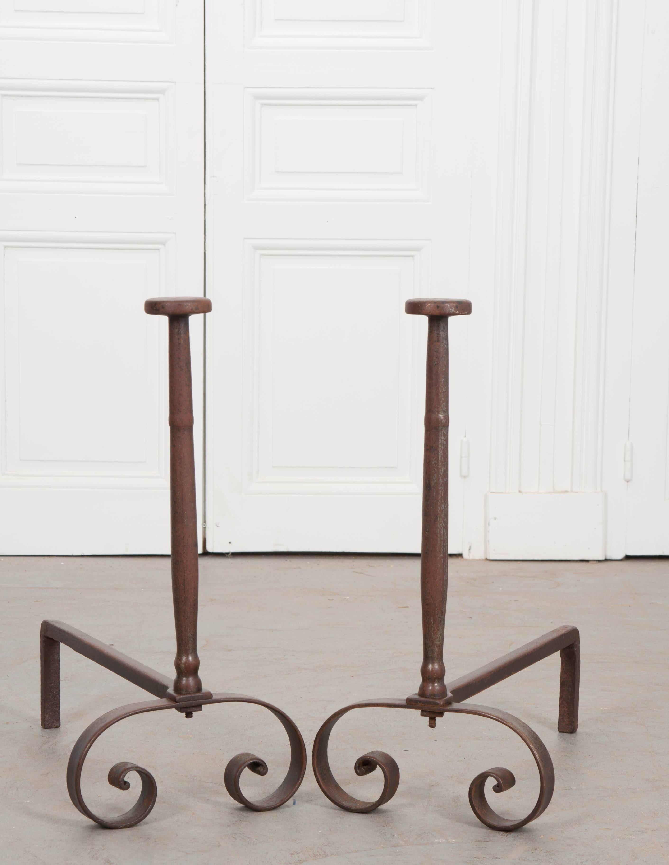 A wonderful pair of column-form heavy iron andirons, made in France during the 19th century. The iron has taken on a lovely patina thanks to years of fires enjoyed by the andiron’s previous owner. The design is conservative and classic, with