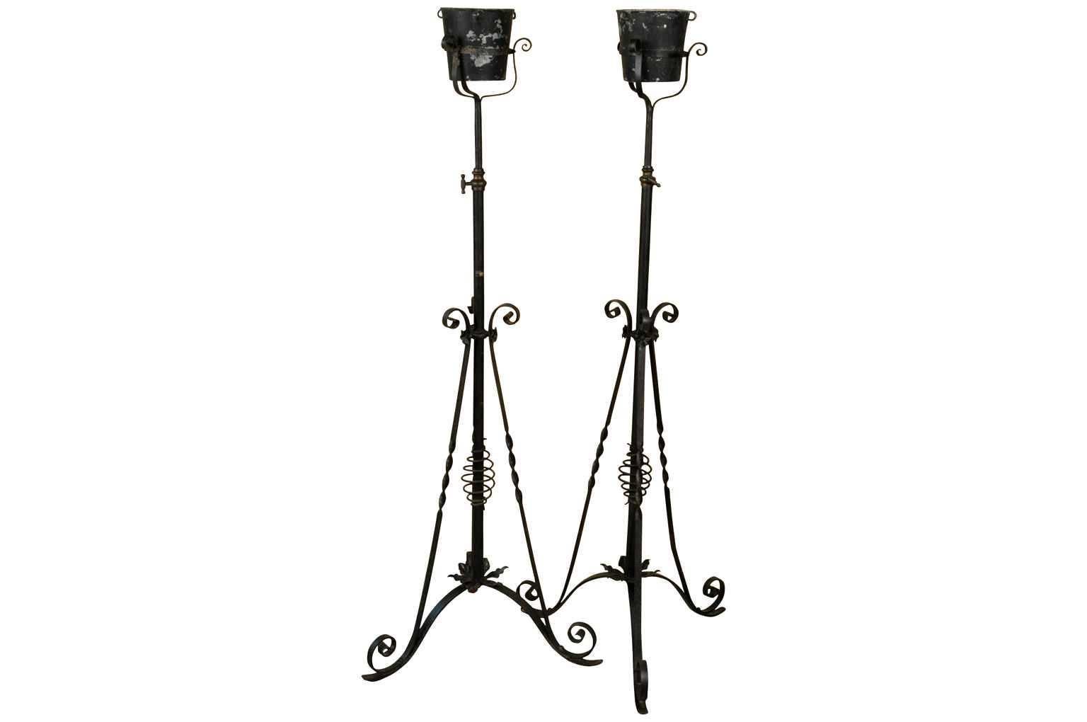 A very handsome later 19th century French iron Torcheres - floor standing candelabras. Wonderful construction allowing to raise and lower the height of the torcheres. Terrific accent pieces.