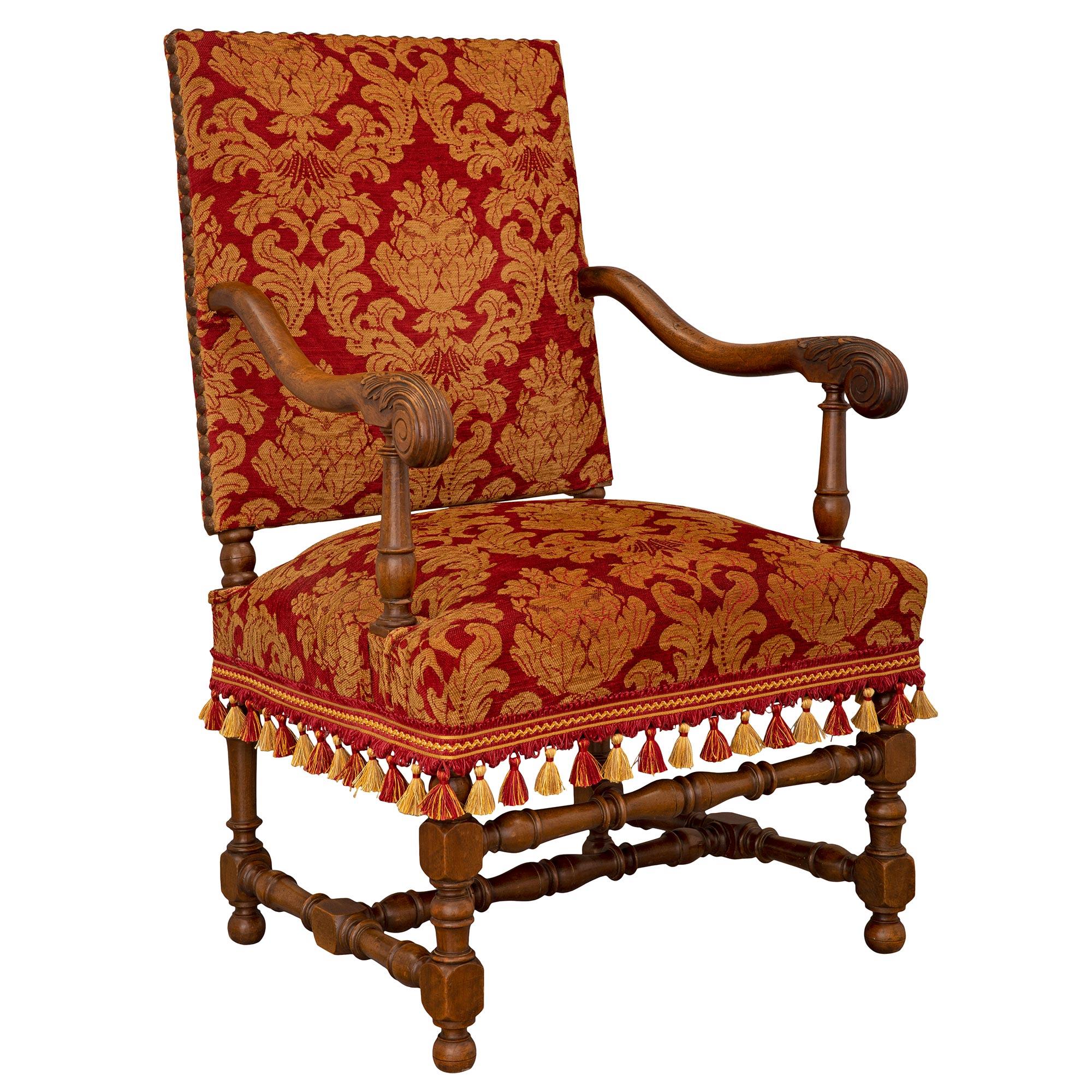 A handsome and most impressive pair of French 19th century Louis XIII st. oak armchairs. Each armchair is raised by fine ball feet below block and turned legs and beautifully turned and mottled stretchers. The arms display elegant and most