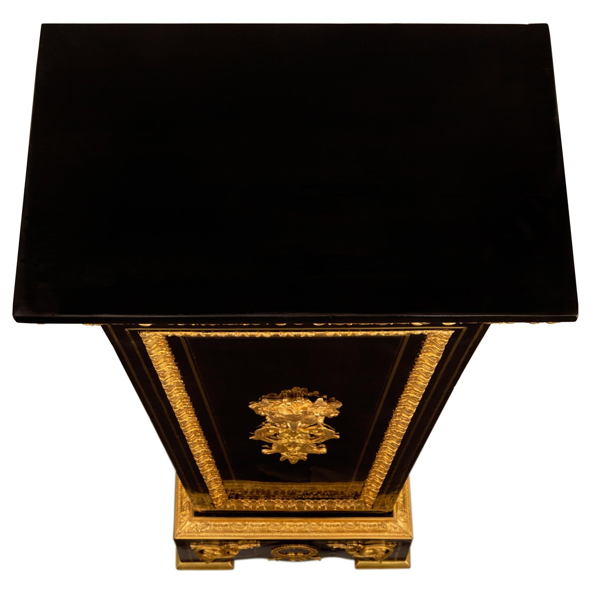An exceptional and very high quality pair of French 19th century Louis XIV st. Ebony, brass, giltwood and ormolu Boulle st. pedestals. Each pedestal is raised by fine giltwood feet below the rectangular base with an arched front and sides decorated