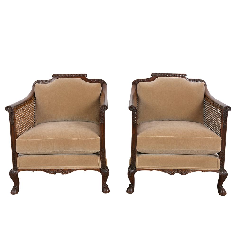 This 1850s set of French Louis XIV-style bergeres has been recently restored and are made out of walnut wood. The sturdy wood frame has a rich walnut color with hand carved foliage details all throughout the frame. It has the original caning, which