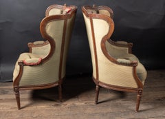 Pair of French 19th Century Louis XV Carved Walnut Wing Bergeres Armchairs