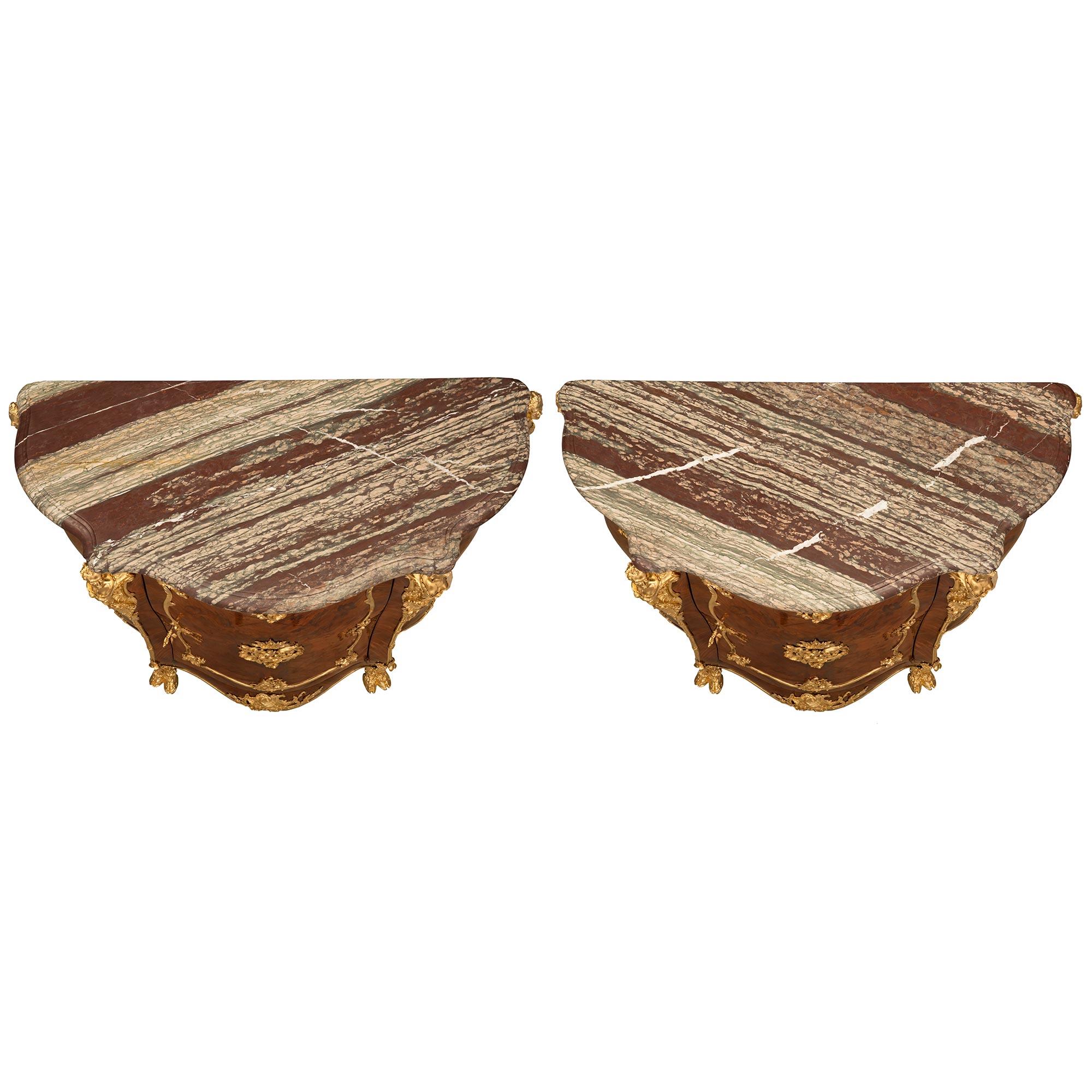 A sensational and extremely high quality pair of French 19th century Louis XV st. Belle Époque period Kingwood, Tulipwood, ormolu, and Campan Rubané marble cabinets attributed to Joseph-Emmanuel Zwiener. Each cabinet is raised by impressive and very