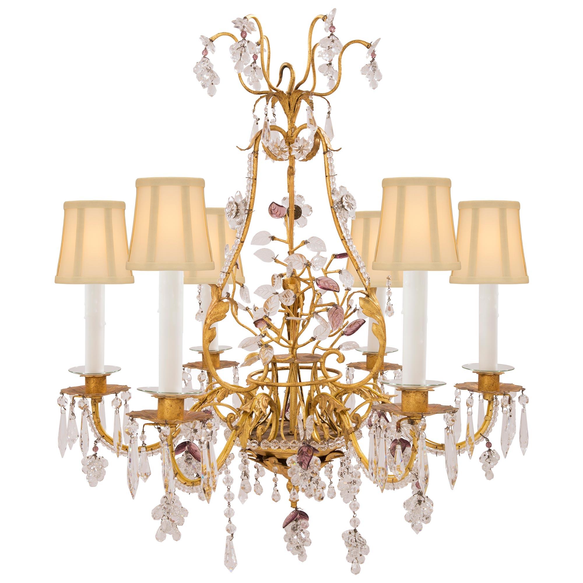 An exceptional pair of French 19th century Louis XV st. gilt metal, Baccarat crystal and cut glass chandeliers, attributed to Maison Bagues. Each of the six arm chandeliers is centered by a charming and most decorative bottom pendant with lovely