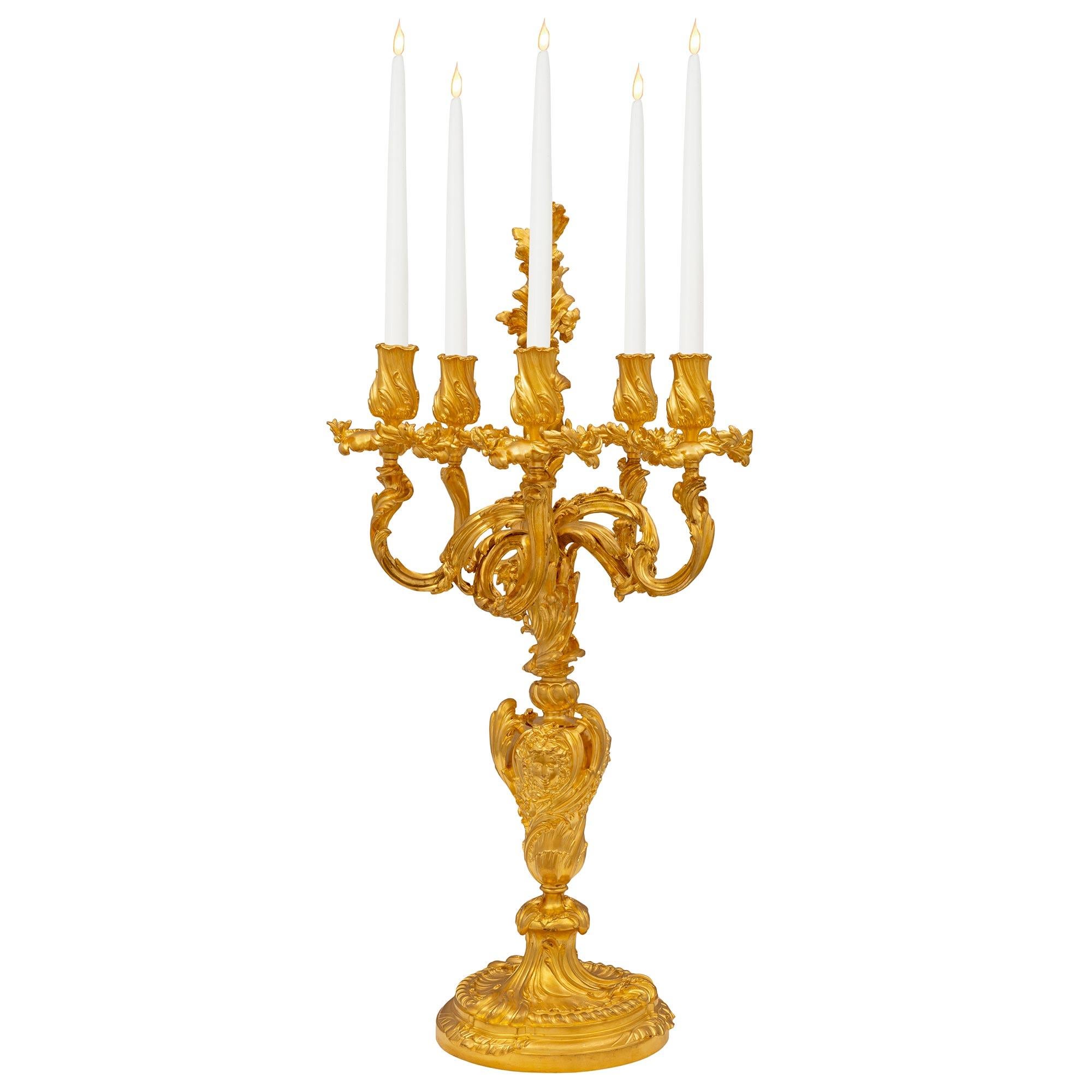 A stunning and monumentally scaled pair of French 19th century Louis XV st. ormolu candelabras, signed Germain. Each uniquely designed five arm candelabra is raised by a fine mottled circular base with a lovely foliate and reeded design. The central