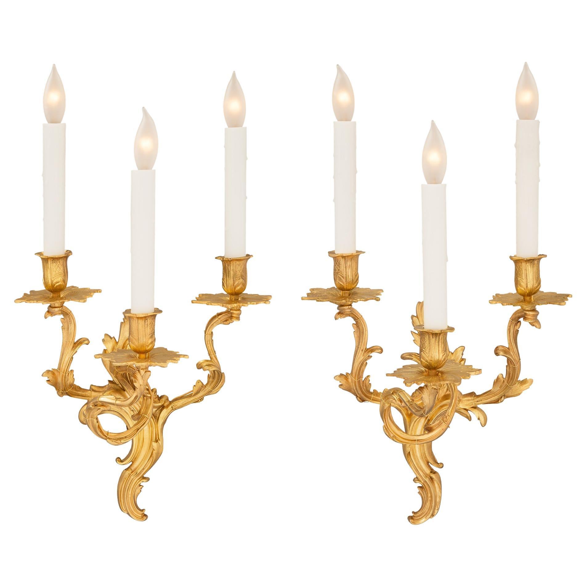 Pair of French 19th Century Louis XV St. Ormolu Three-Arm Sconces For Sale