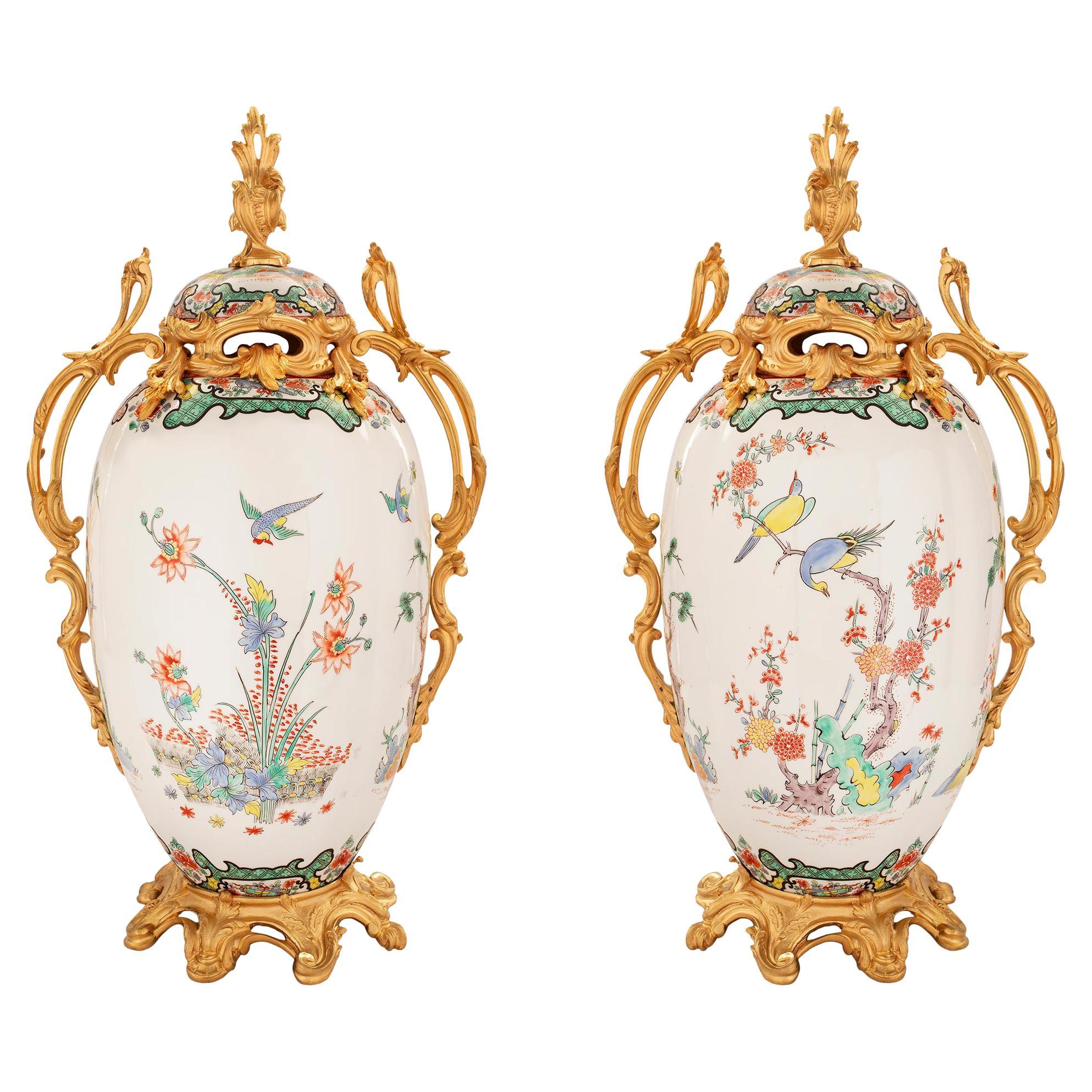 Paar französische Urnen mit Deckel aus Porzellan und Goldbronze im Stil Louis XV. des 19. Jahrhunderts