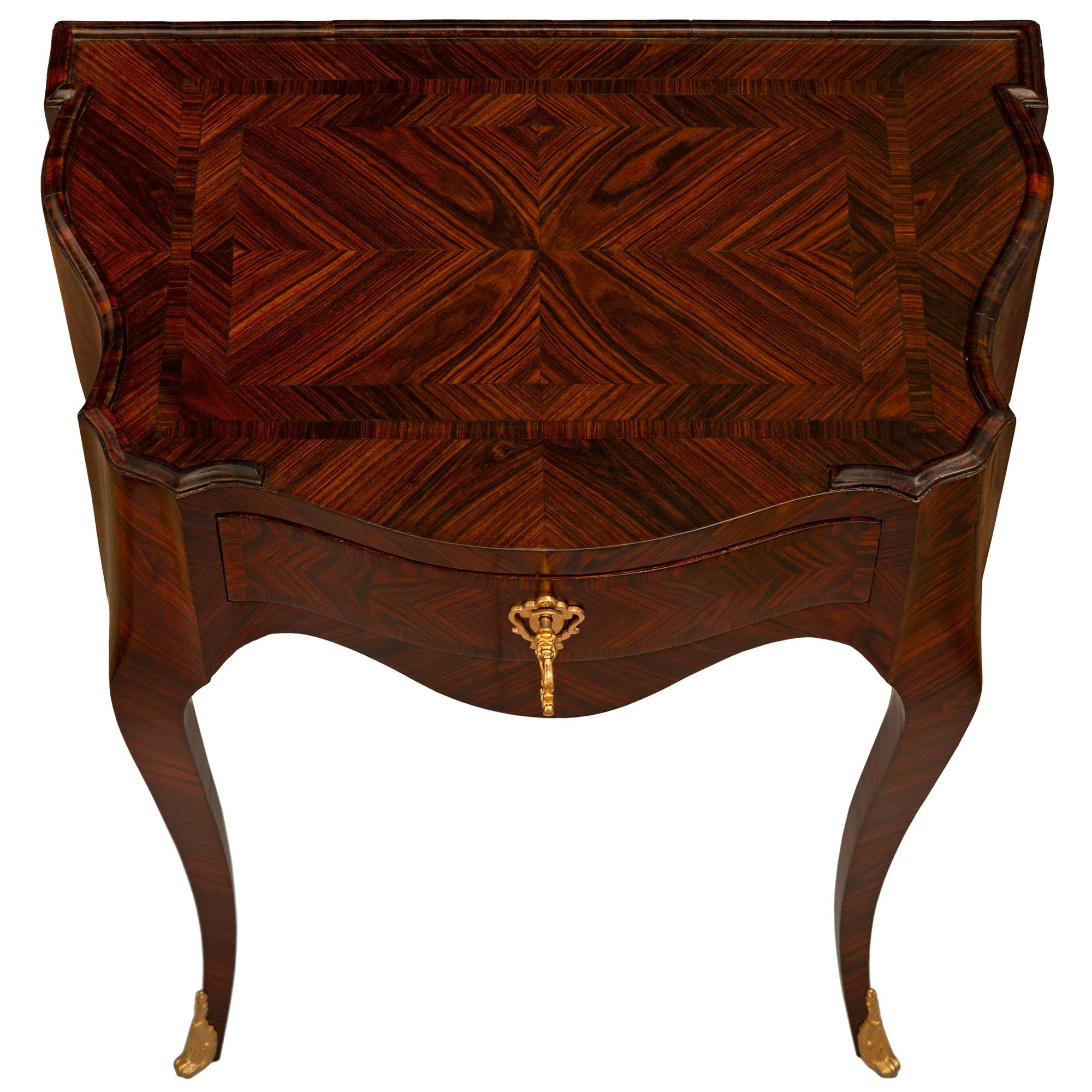 A beautiful and high quality pair of Italian 19th century Genovese st. Rosewood and Ormolu side tables. Each exceptional single drawer side table is raised by four tapered cabriole legs with Ormolu foliate sabots on the two front legs. The arbalest