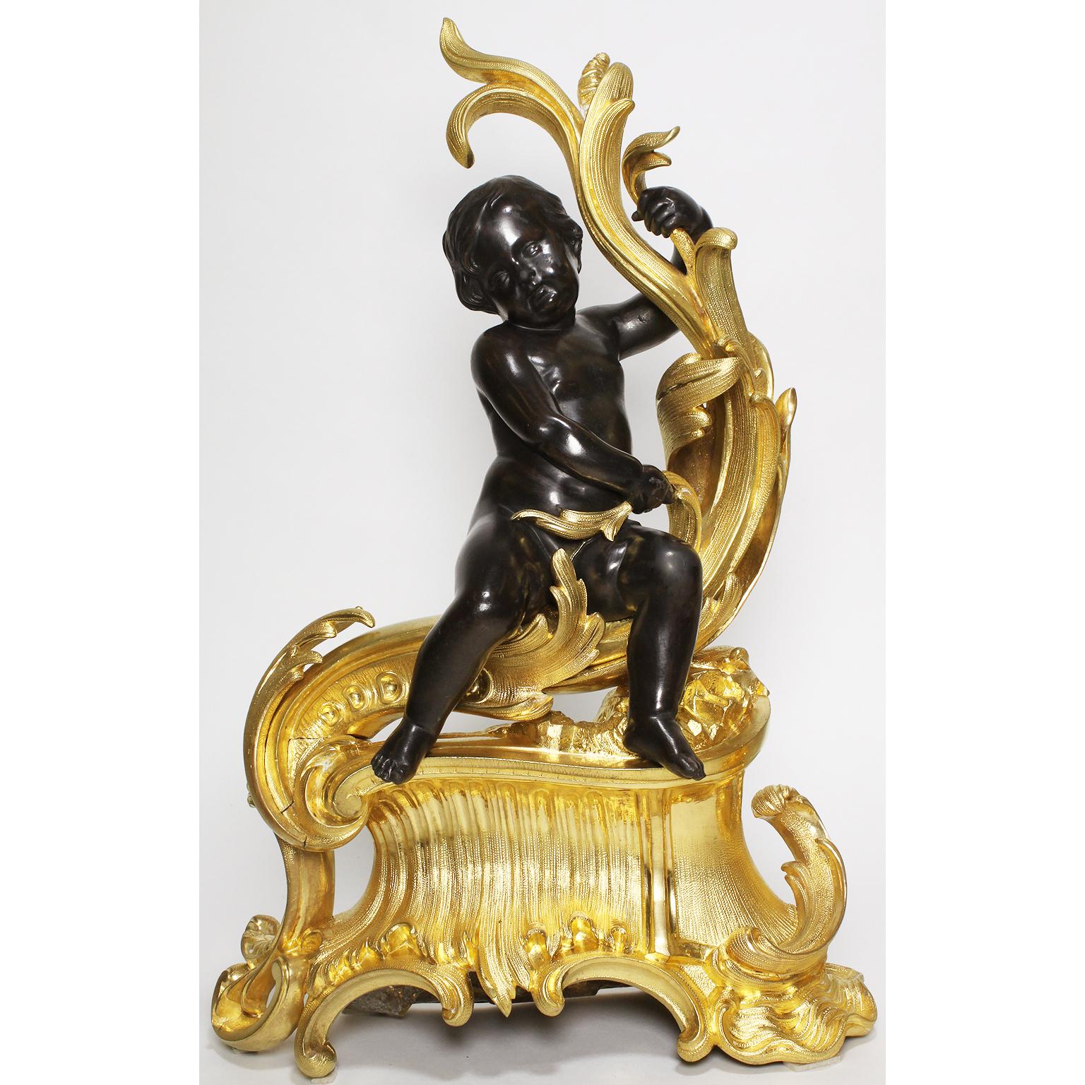 A very fine and charming pair of French 19th century Louis XV style figural gilt and patinated bronze chenets, each surmounted with a seated patinated bronze putto holding on to a branches, over a scrolled gilt bronze plinth, Paris, circa