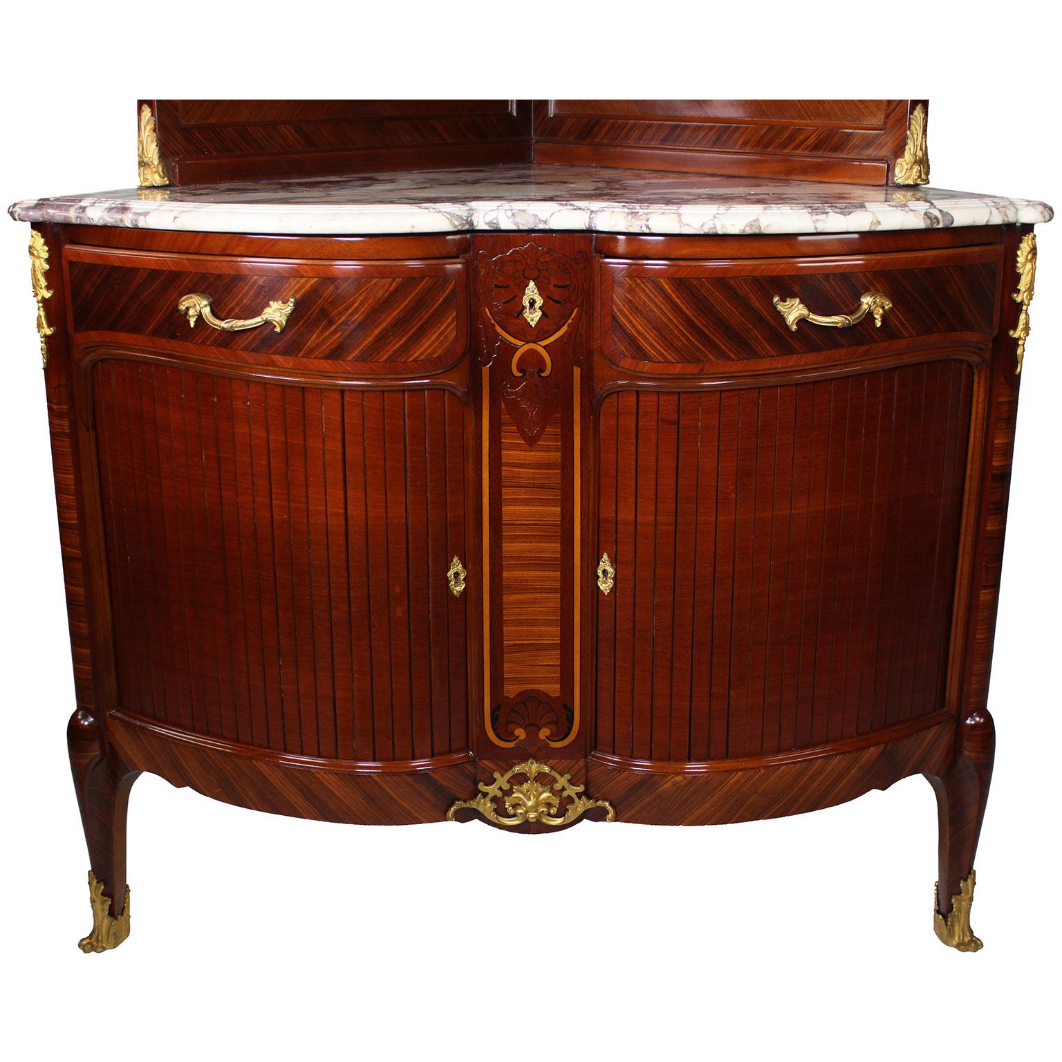 Impressive pair of French 19th century Louis XV style gilt bronze-mounted Kingwood and mahogany marquetry Encoigneurs, corner cabinets or vitrines, attributed to Paul Sormani. The upper section with molded cornice and shell cresting and enclosed by