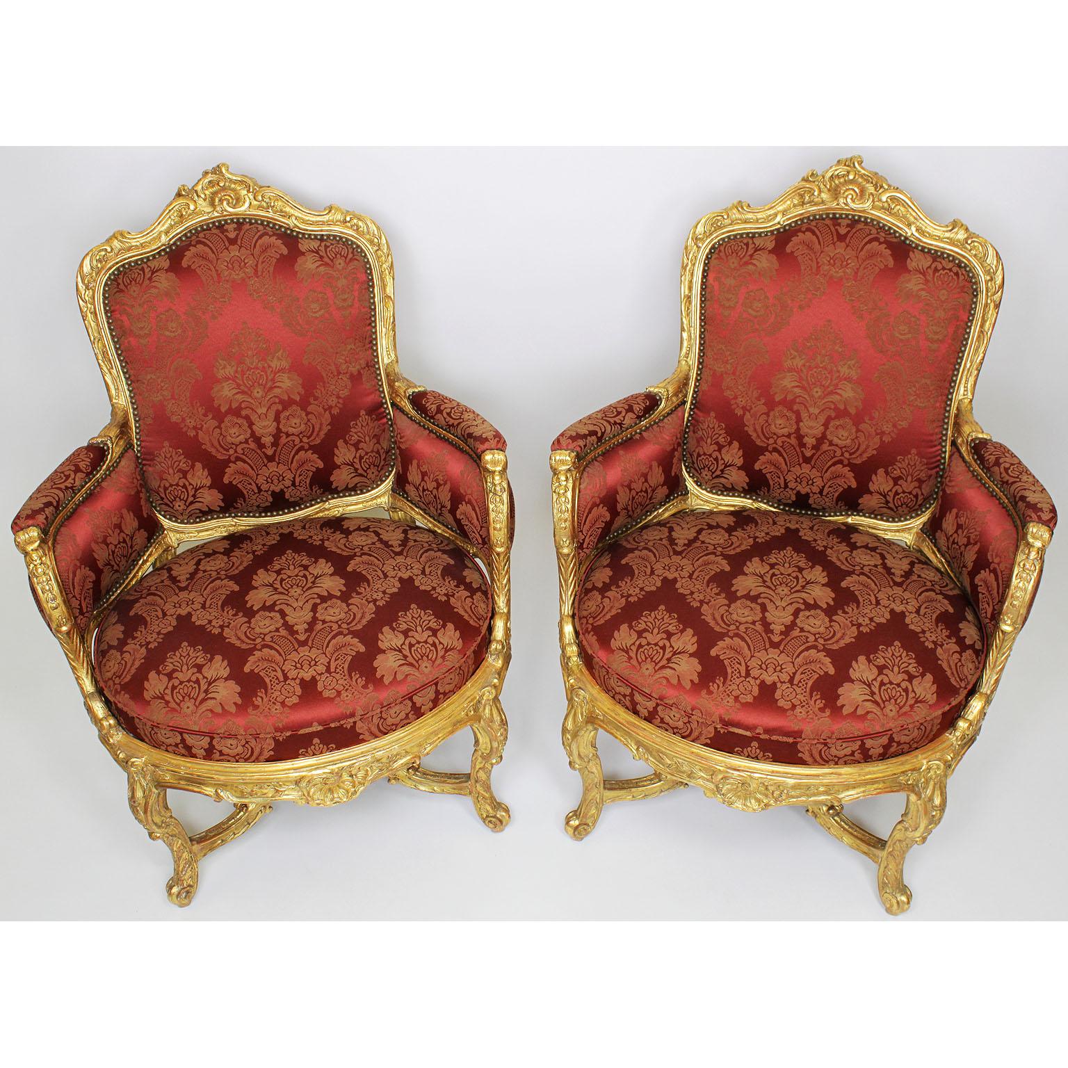 A very Fine pair of french 19th century Louis XV style giltwood carved marquises bergère armchairs. The ornately carved gilded frames with floral and acanthus motifs with rounded edges, padded upholstered sides and armrests, on four cabriolet legs