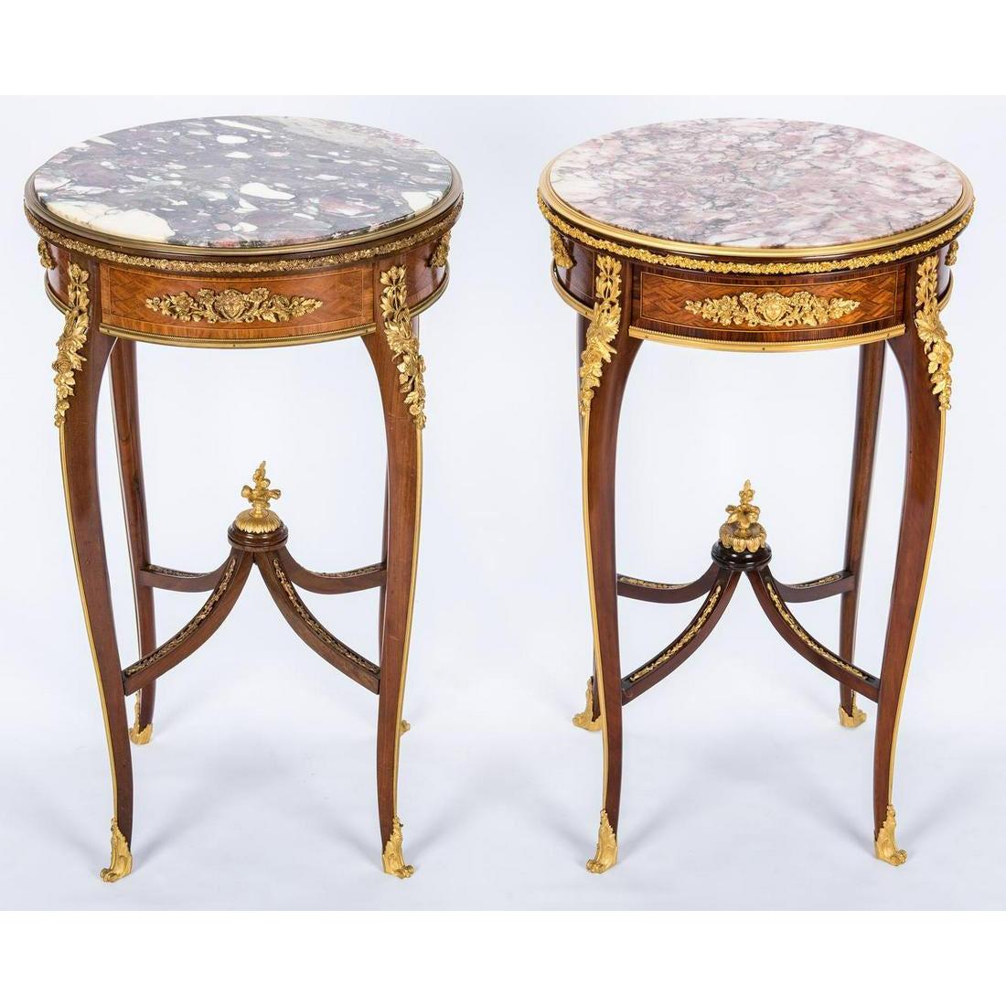A very fine pair of French 19th-20th century gilt bronze (Ormolu) mounted, mahogany and tulipwood parquetry round gueridon (side) tables with marble top, attributed to François Linke (1855-1946). The inset round brocatelle d'Espagne marble top above