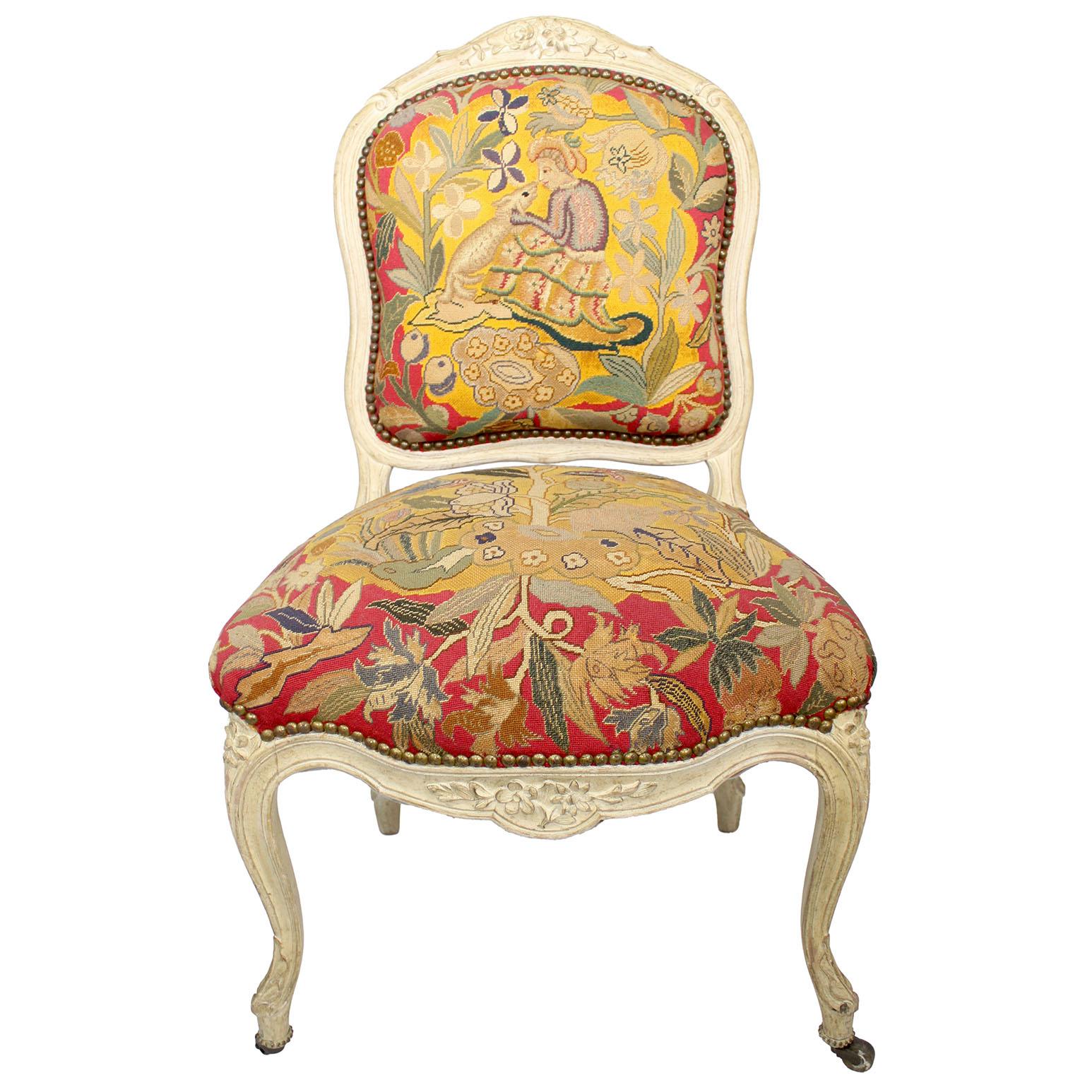 A Pair of French 19th Century Louis XV Style White-Lacquer-Finished and Needlepoint Tapestry Side Chairs, the front legs with coasters. Circa: Paris, 1890-1900.

Height: 36 1/2 inches (92.7 cm)
Width: 22 inches (55.9 cm)
Depth: 22 7/8 inches (58.1