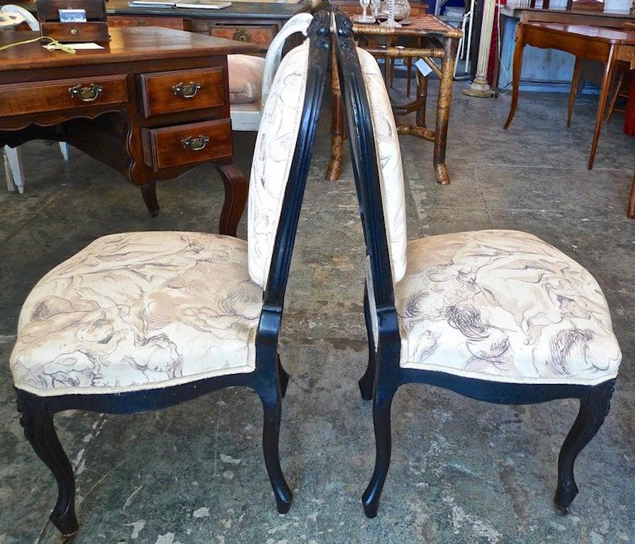 Pair of French 19th century Louis XVI black rosewood vanity chairs on front castors.