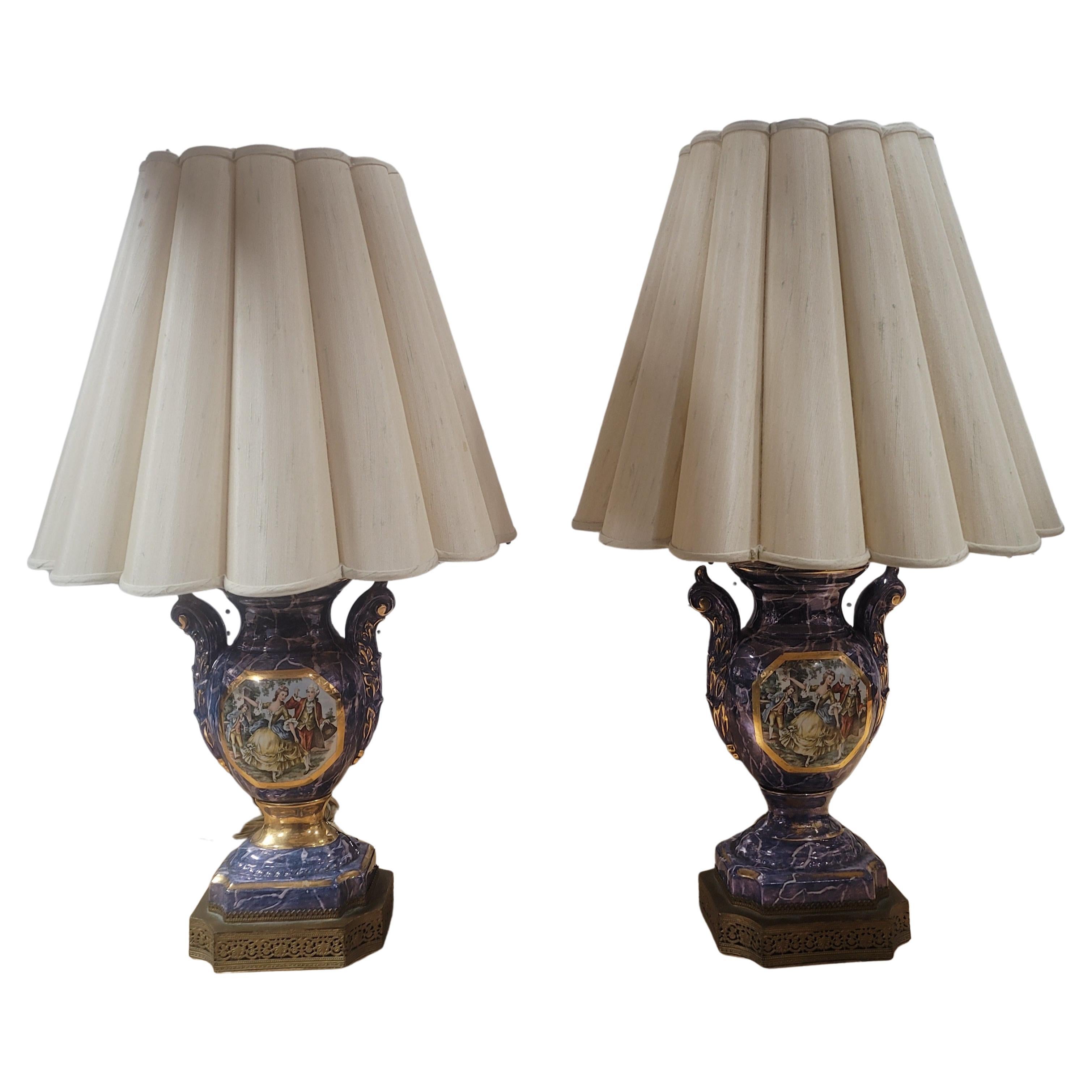 An elegant pair of French 19th century Louis XVI Sèvres Style porcelain lamps. Each lamp is raised by a mottled base decorated with fine decorated brass wrap. Above the socle shaped pedestals, the urn shaped bodies are decorated with beautiful