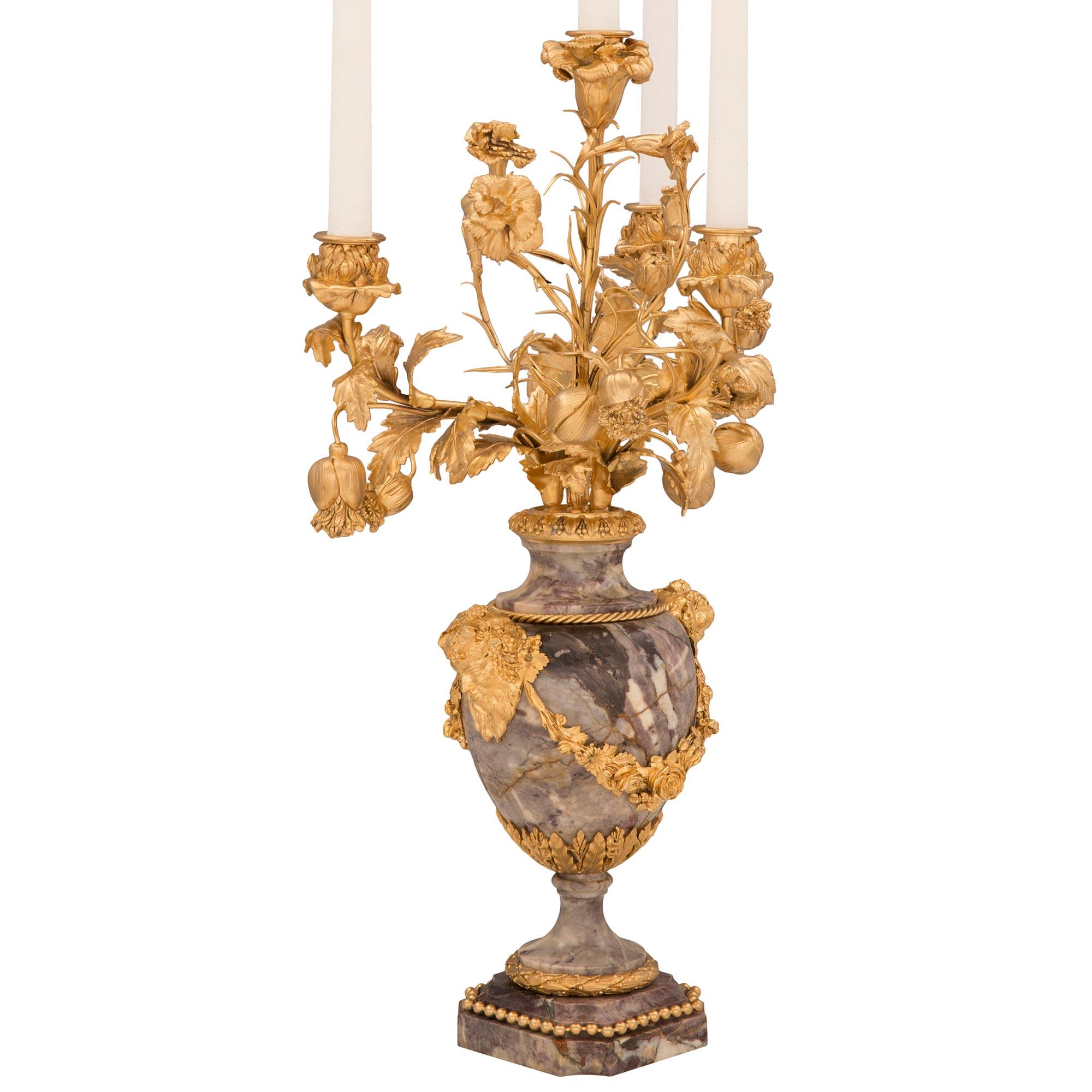 A superb and extremely high quality pair of French 19th century Louis XVI st. Belle Époque period Brèche Violette marble and ormolu candelabras. Each candelabra is raised by a square base with concave corners, a stepped design adorned with wrap