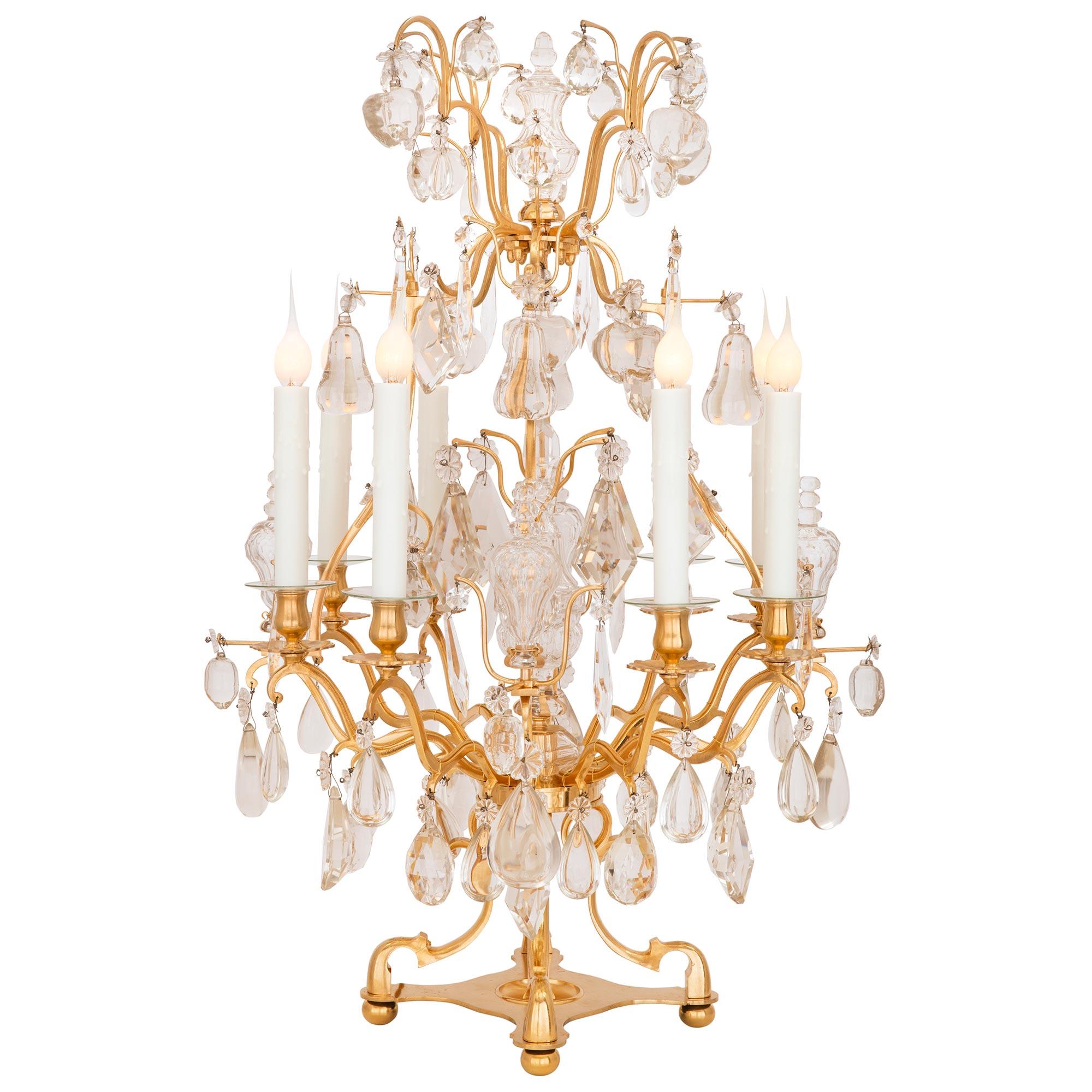 A stunning pair of French 19th century Louis XVI st. Belle Époque period ormolu and Baccarat crystal girandole lamps. Each eight arm lamp is raised by a unique and most decorative ormolu base with ball feet and fine beautifully scrolled supports