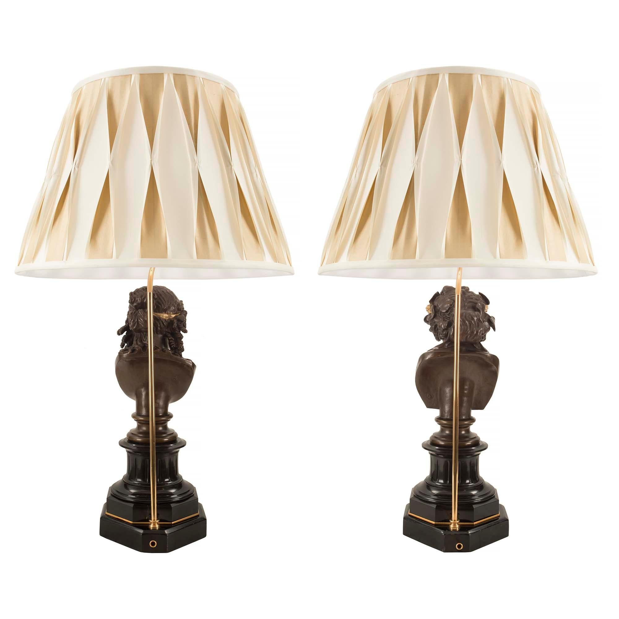 A most impressive and high quality true pair of French 19th century Louis XVI st. patinated bronze, black Belgian marble and ormolu lamps of Bacchus and Diana the Huntress signed F. Barbedienne. Each lamp is raised by an octagonal stepped black