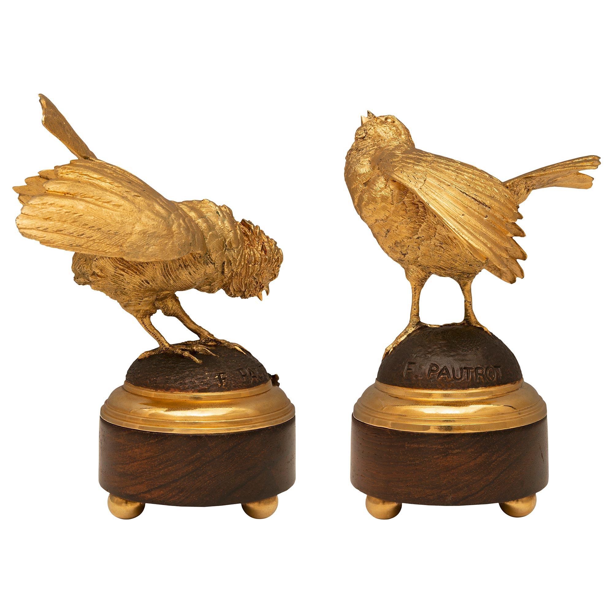 A charming and very high quality small scale pair of French 19th century Louis XVI st. Belle Époque period ormolu, patinated bronze and Walnut statues signed F. Pautrot. Each statue is raised by three elegant ball feet below the circular Walnut base