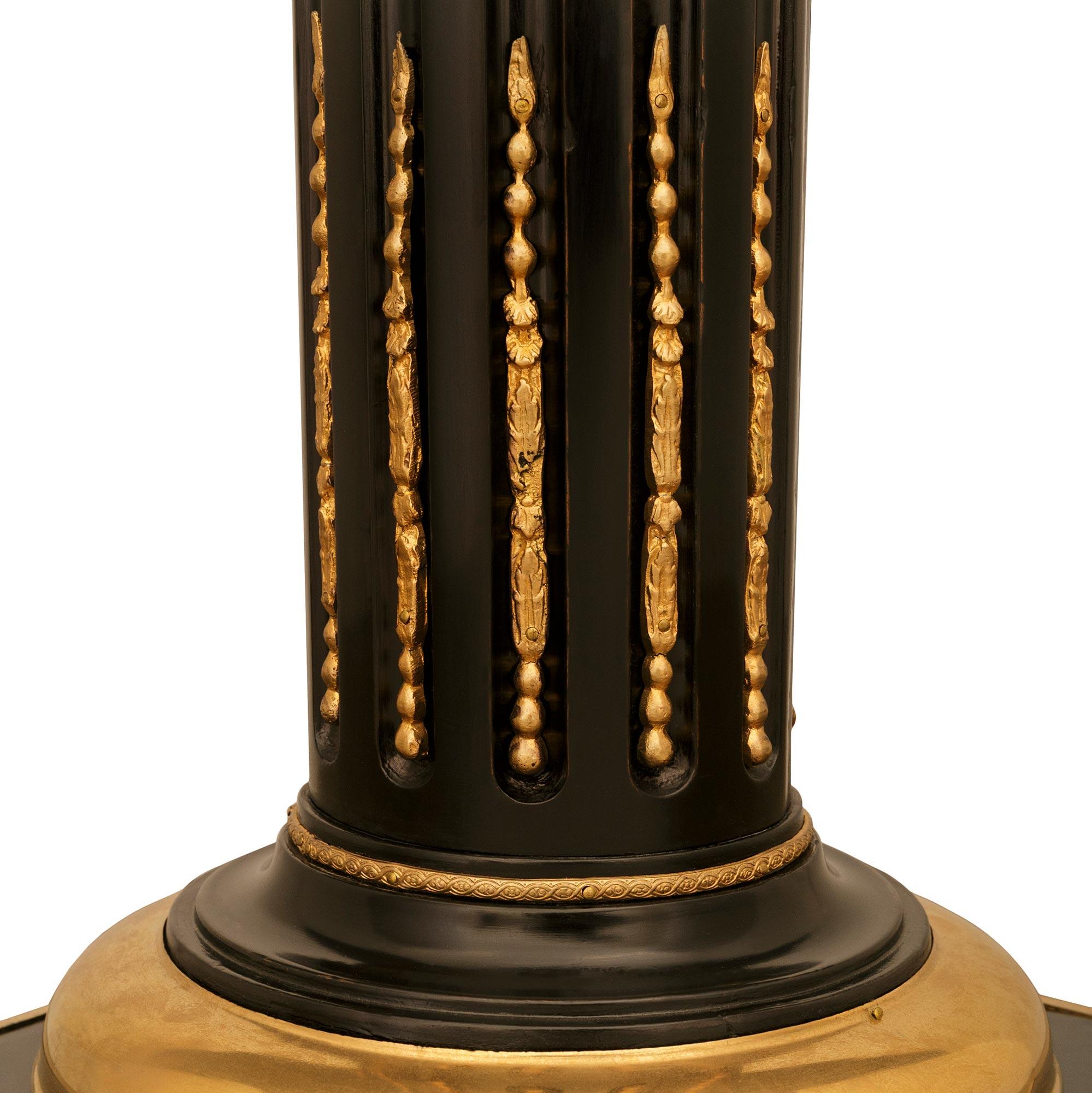 An impressive and extremely elegant pair of French 19th century Louis XVI st. Ebony, Ormolu and Marble pedestals. Each stunning pedestal is raised by a square Ebony base with a fine wrap around foliate Ormolu band. The central Ebony supports display