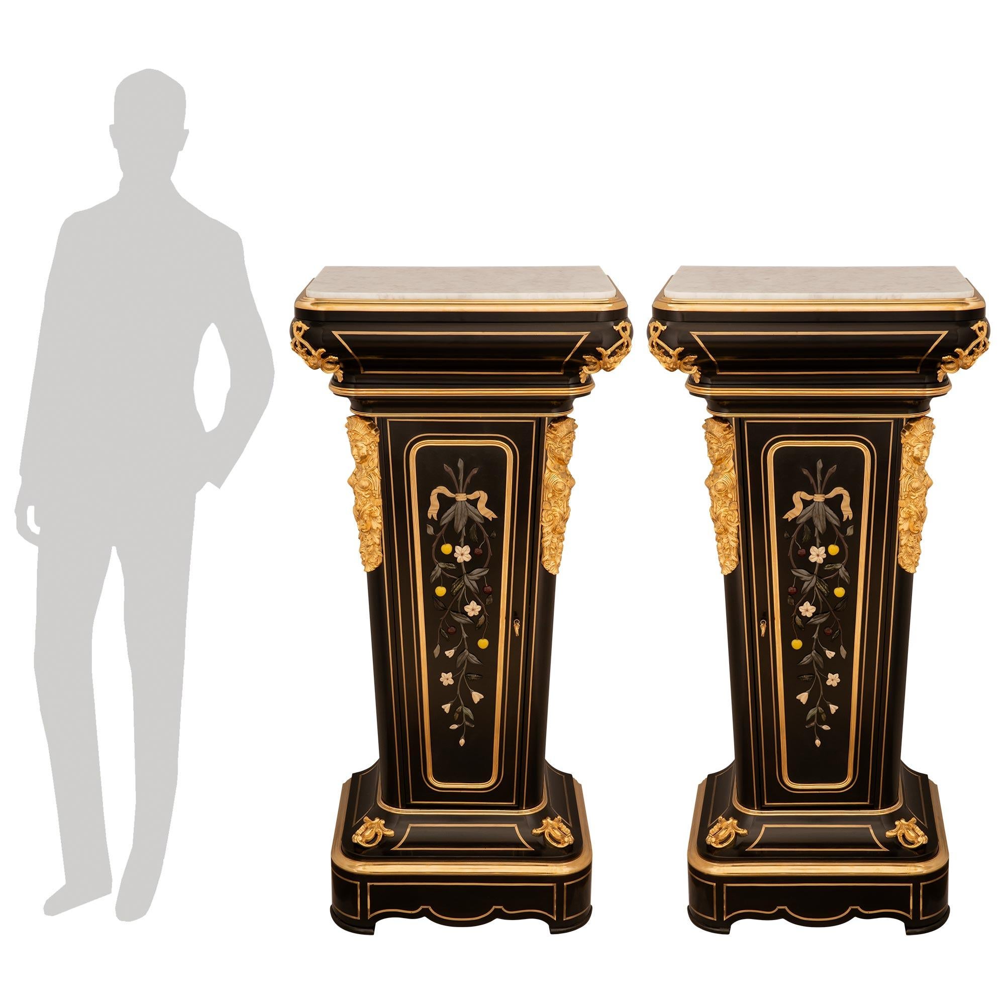 Ein spektakuläres und extrem hochwertiges Paar französischer Louis XVI-Sockel aus dem 19. Jahrhundert aus Ebenholz, Ormolu, Hartstein, Messing und weißem Carrara-Marmor. Jeder wirklich beeindruckende eintürige Sockel steht auf einem quadratischen