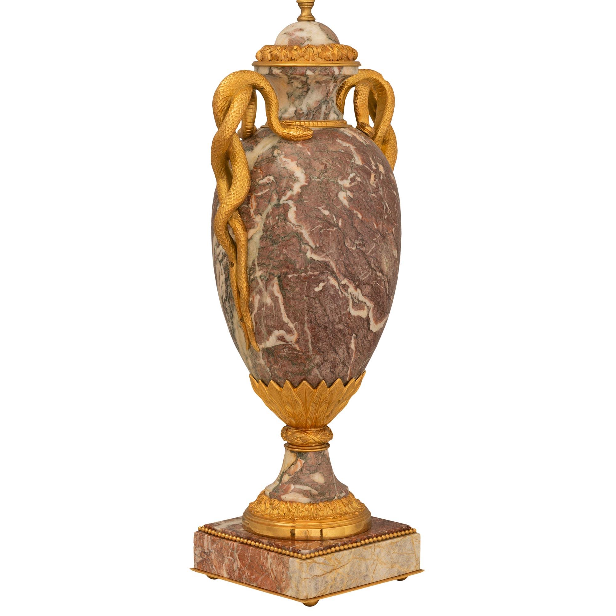 A stunning and very high quality pair of French 19th century Louis XVI st. Brèche Violette marble and ormolu lamps. Each large scale lamp is raised by a square base with fine ormolu ball feet, a lovely bottom fillet, and a delicate wrap around
