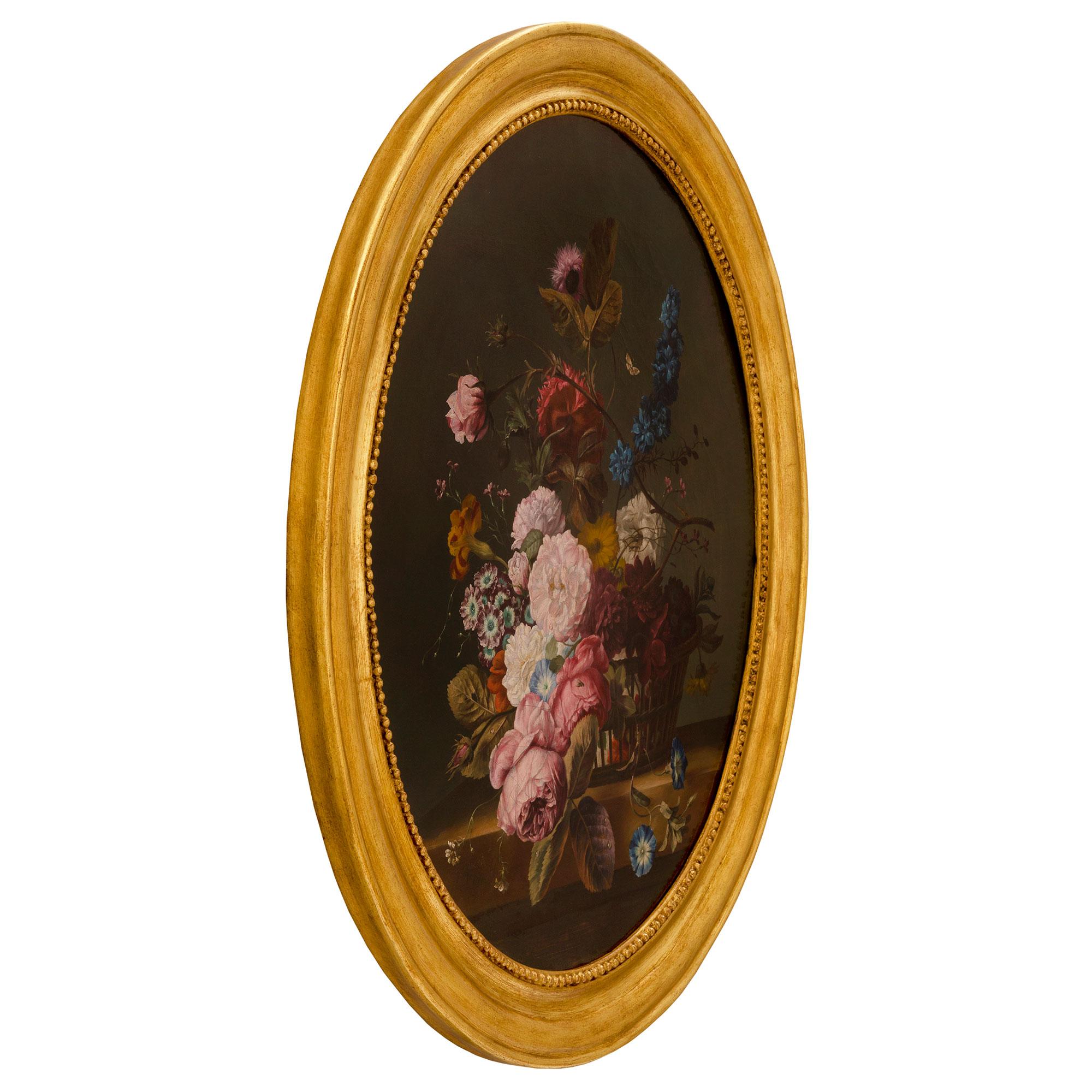 A fine and very decorative pair of French 19th century Louis XVI st. oil on canvas still life paintings. Each oval shaped painting is set within their original elegant giltwood frame with a mottled and beaded design. The painting depicts charming