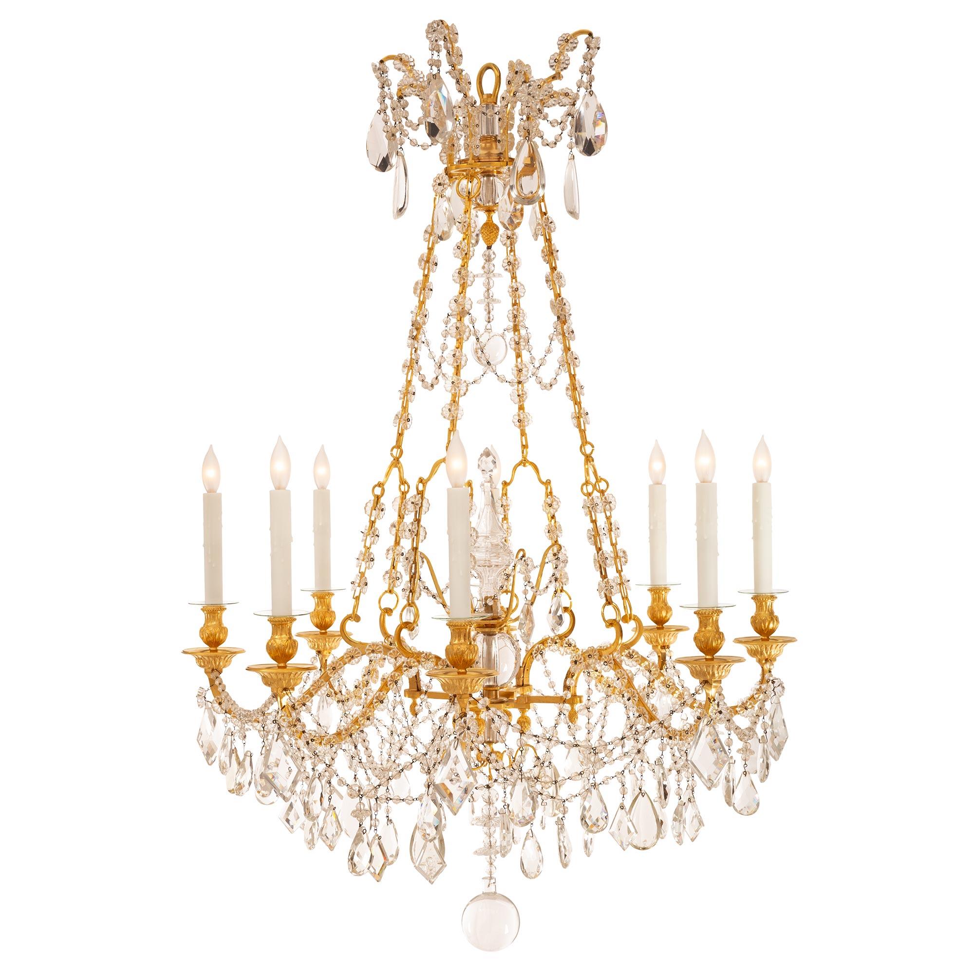 A stunning and extremely elegant pair of French 19th century Louis XVI st. ormolu and Baccarat crystal chandeliers from the collection of Charles Aznavour. Each Marie Antoinette st. eight arm chandelier is centered by a beautiful solid Baccarat