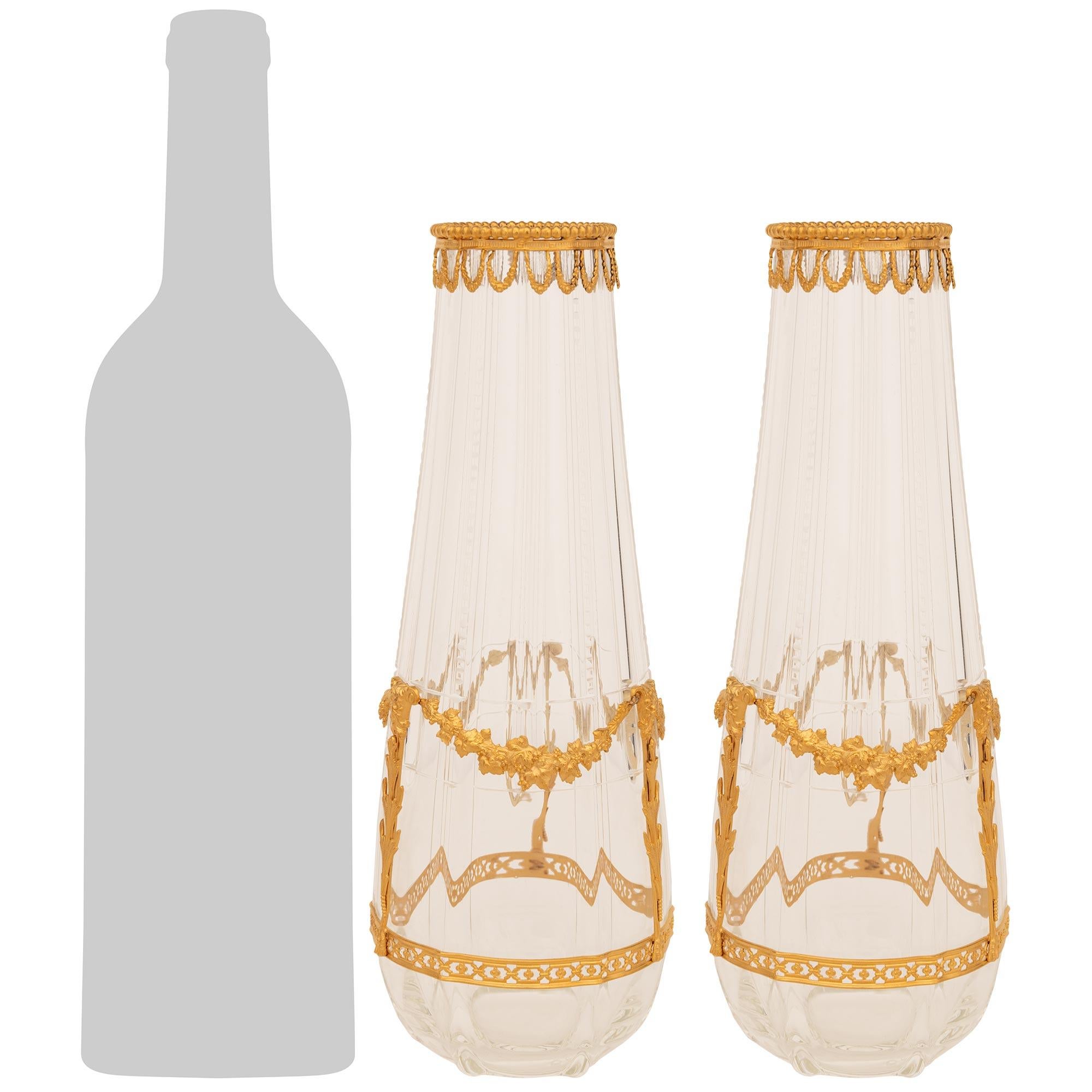 Una coppia squisita e molto decorativa di vasi francesi del XIX secolo St. Louis Crystal e Ormolu. Ogni splendido vaso è decorato con gusto da una montatura in Ormolu che presenta una fascia inferiore traforata e ghirlande foliate con bacche