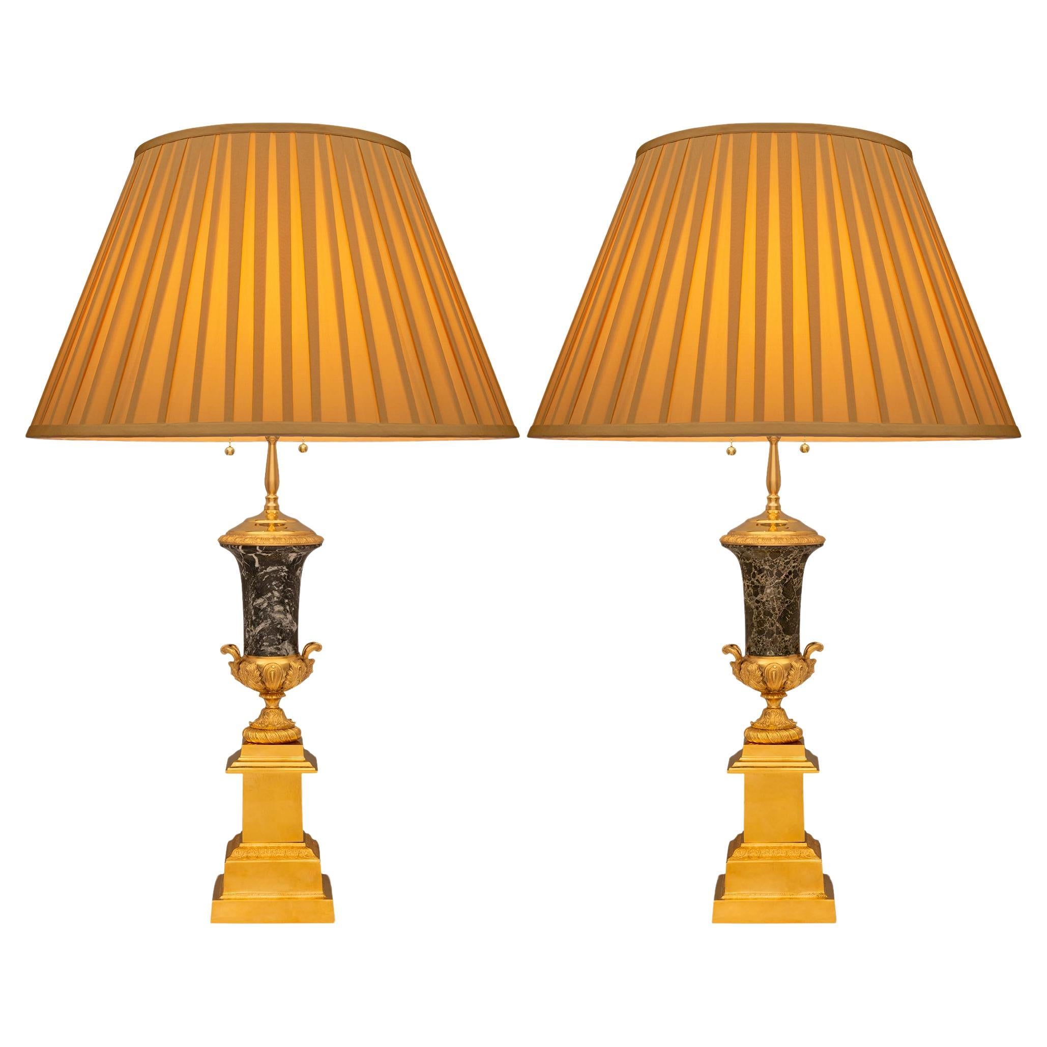 A stunning and most handsome pair of French 19th century Louis XVI st. Ormolu and Breccia Verde marble lamps. Each lamp is raised on a square Ormolu plinth displaying a Coeur-de-Rai band below a smooth Ormolu pedestal. Placed above the mottled and