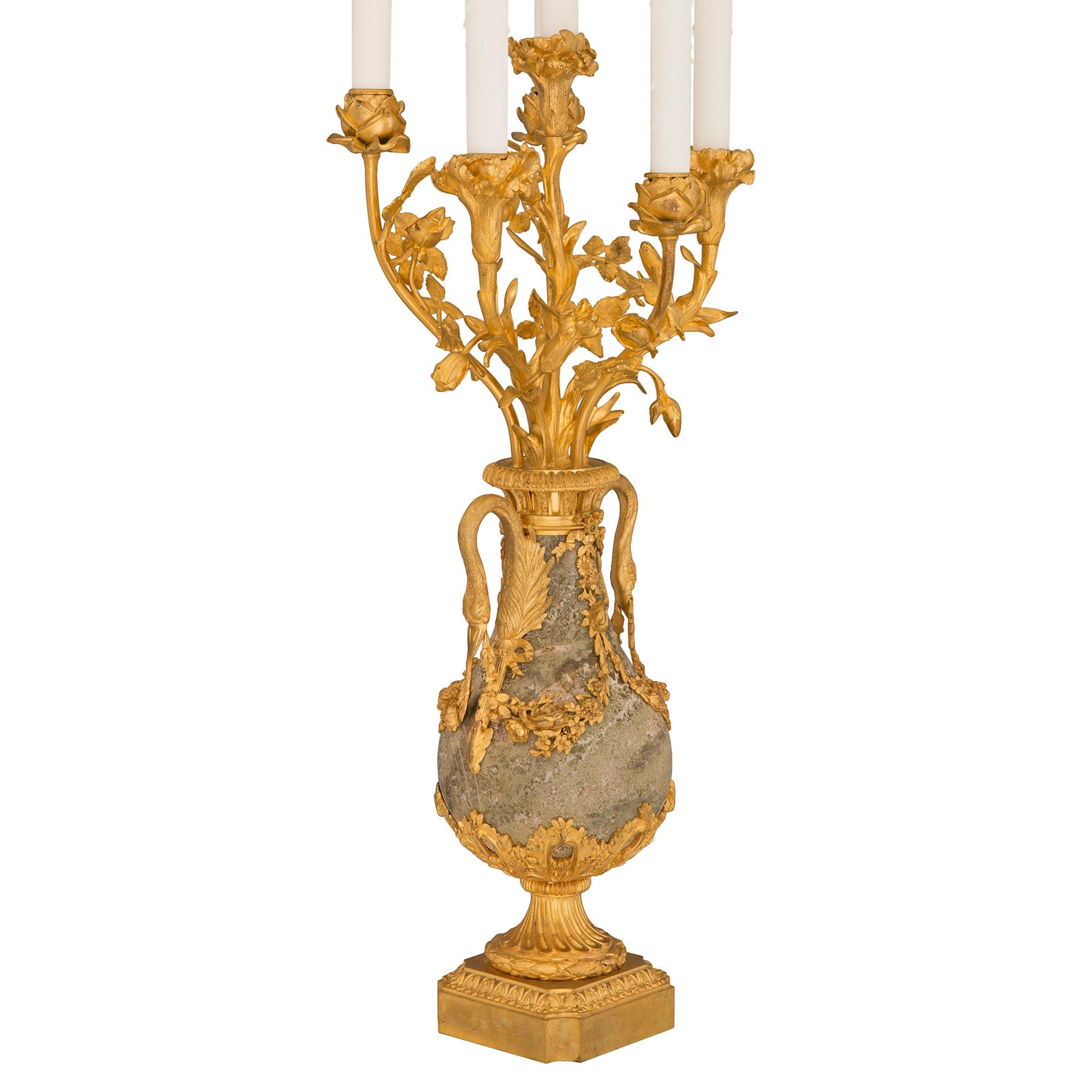 A spectacular and extremely high quality pair of French 19th century Louis XVI st. ormolu and Sarrancolin marble candelabra lamps. Each six arm lamp is raised by an elegant square base with concave corners and a finely mottled wrap around Coeur de