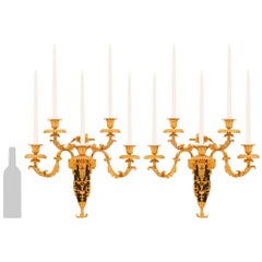 pair of French 19th century Louis XVI st. Ormolu and patinated Bronze sconces