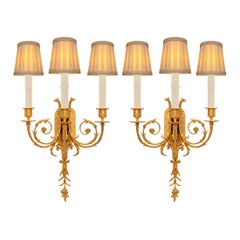 Pair of French 19th Century Louis XVI St. Ormolu and Patinated Bronze Sconces
