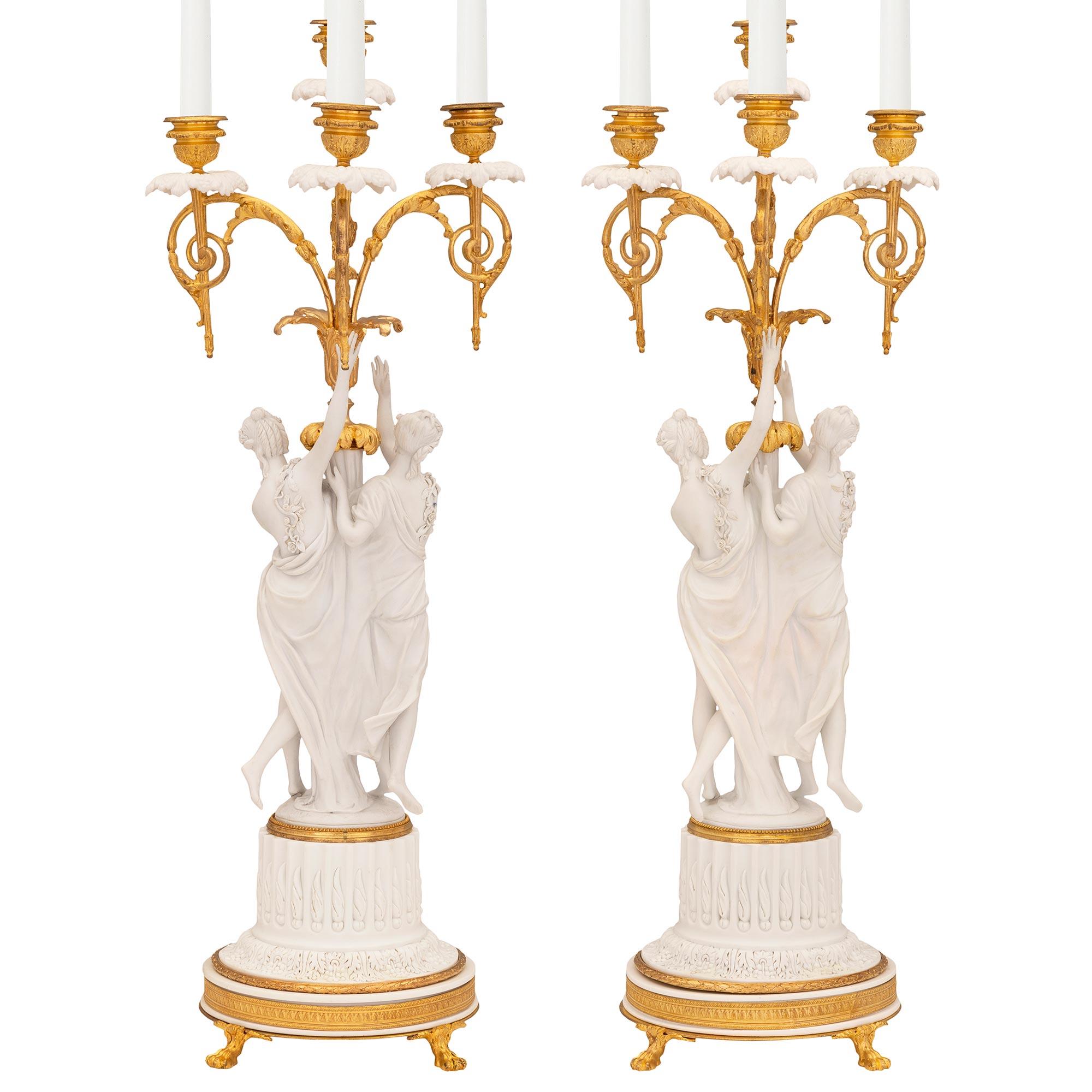 A stunning and very high quality pair of French 19th century Louis XVI st. ormolu and Biscuit de Sèvres porcelain candelabras, signed Sèvres and after a model by Lagneau. Each four arm candelabra is raised by handsome paw feet below an elegant