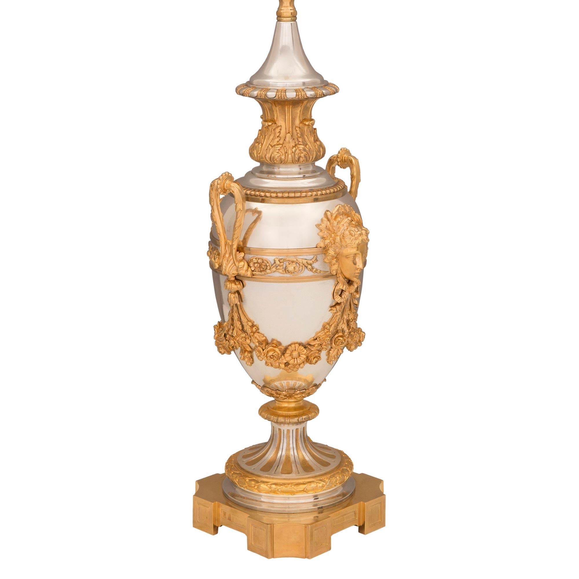 A superb and very high quality pair of French 19th century Louis XVI st. ormolu and silvered bronze lamps, signed by Victor Paillard. Each lamp is raised by elegant square bases with fine block designs and concave corners. The socle shaped pedestals