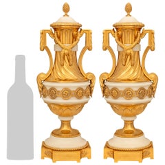 pair of French 19th century Louis XVI st. Ormolu and white Carrara marble urns