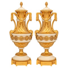 pair of French 19th century Louis XVI st. Ormolu and white Carrara marble urns