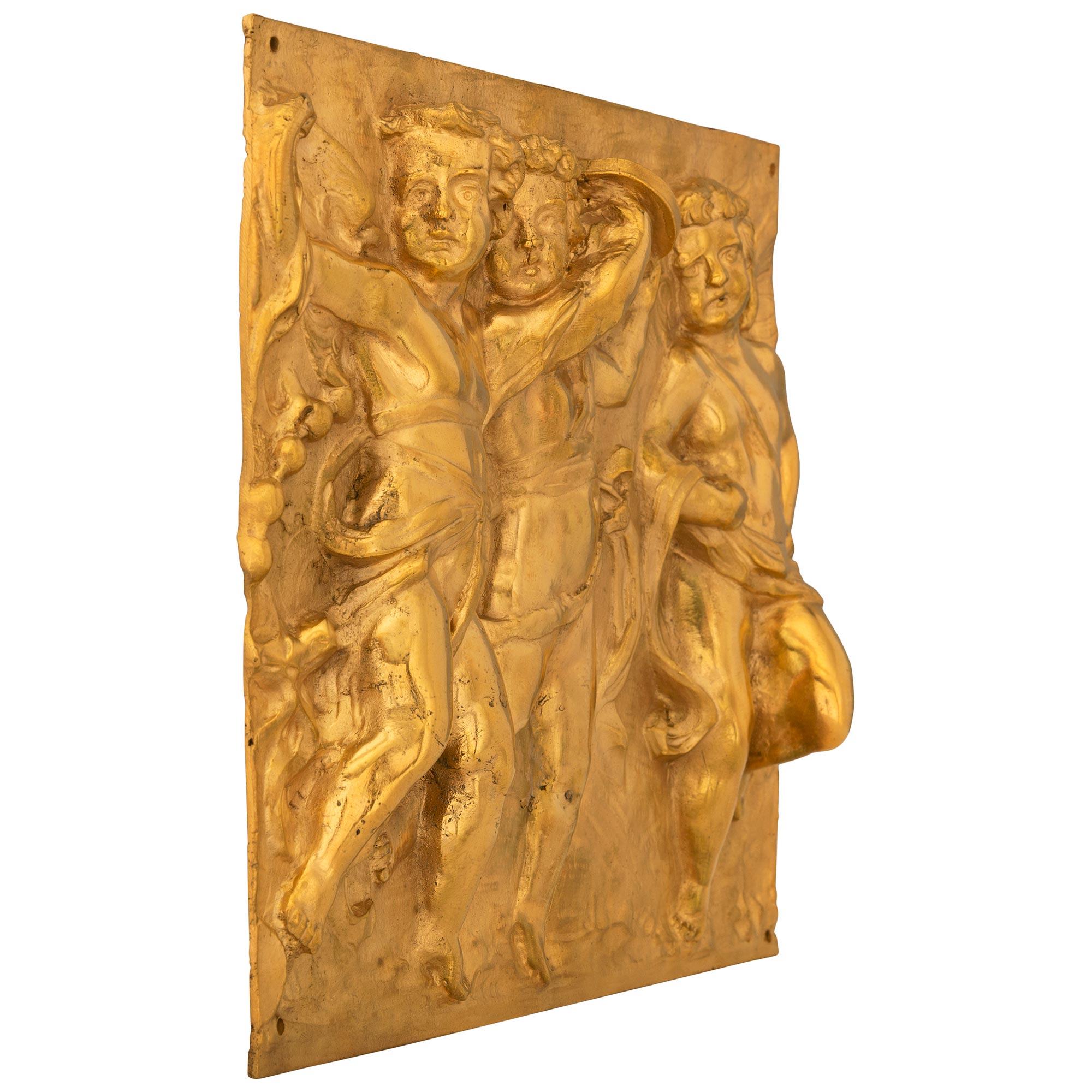 An exceptional pair of French 19th century Louis XVI st. ormolu decorative wall plaques in the manner of Clodion. Each rectangular plaque depicts charming winged cherubs draped in wonderful flowing ribbons and garments joyously dancing and playing