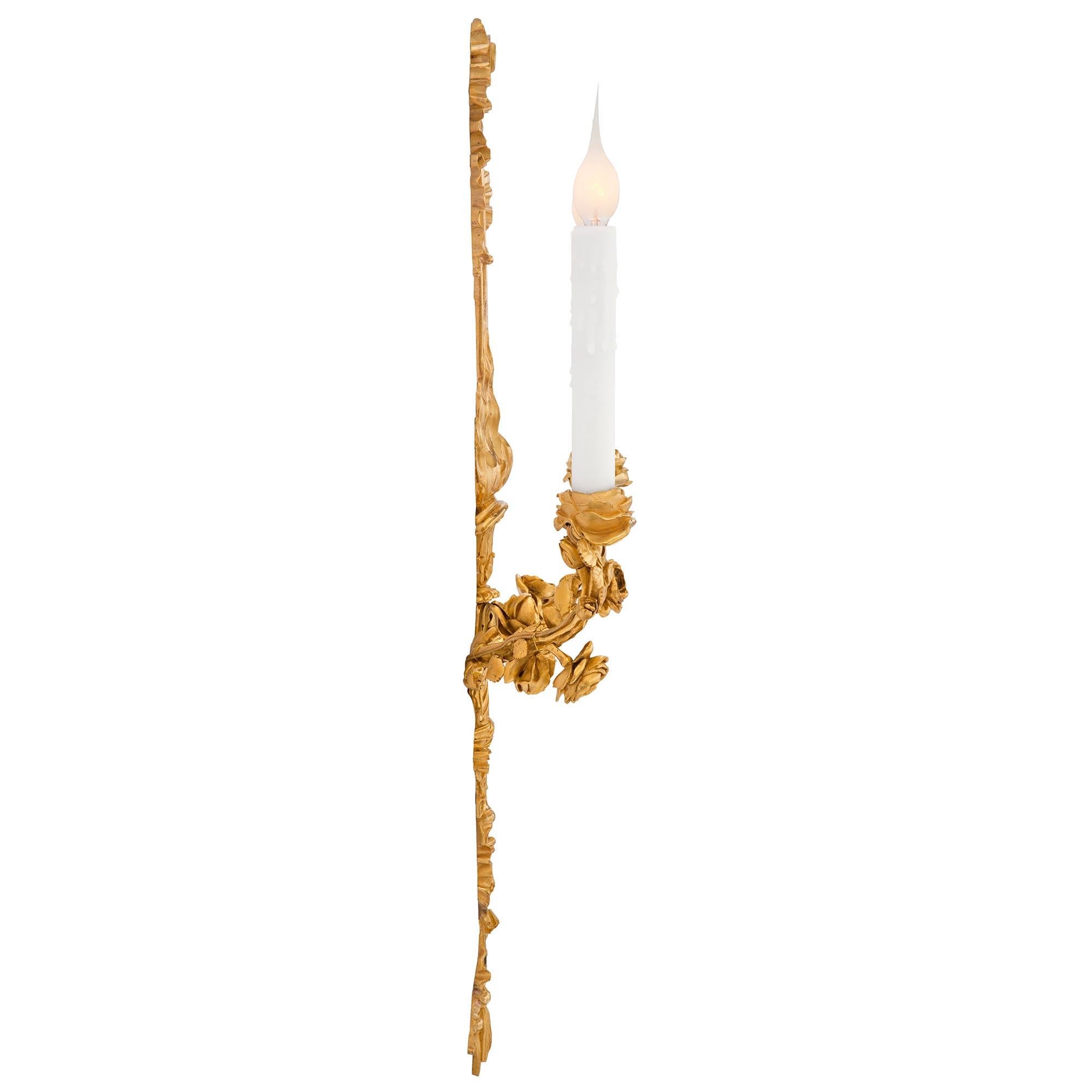A most elegant and very high quality pair of French 19th century Louis XVI st. ormolu sconces. Each two arm sconce is centered by charming tassels tied with a ribbon below the impressive and finely detailed eternal flame and lovely top ribbon. Each