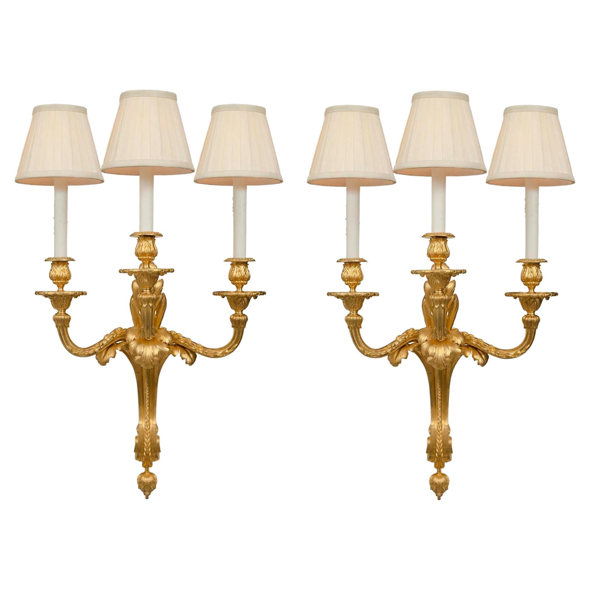 Pair of French 19th Century Louis XVI St. Ormolu Three-Arm Sconces For Sale