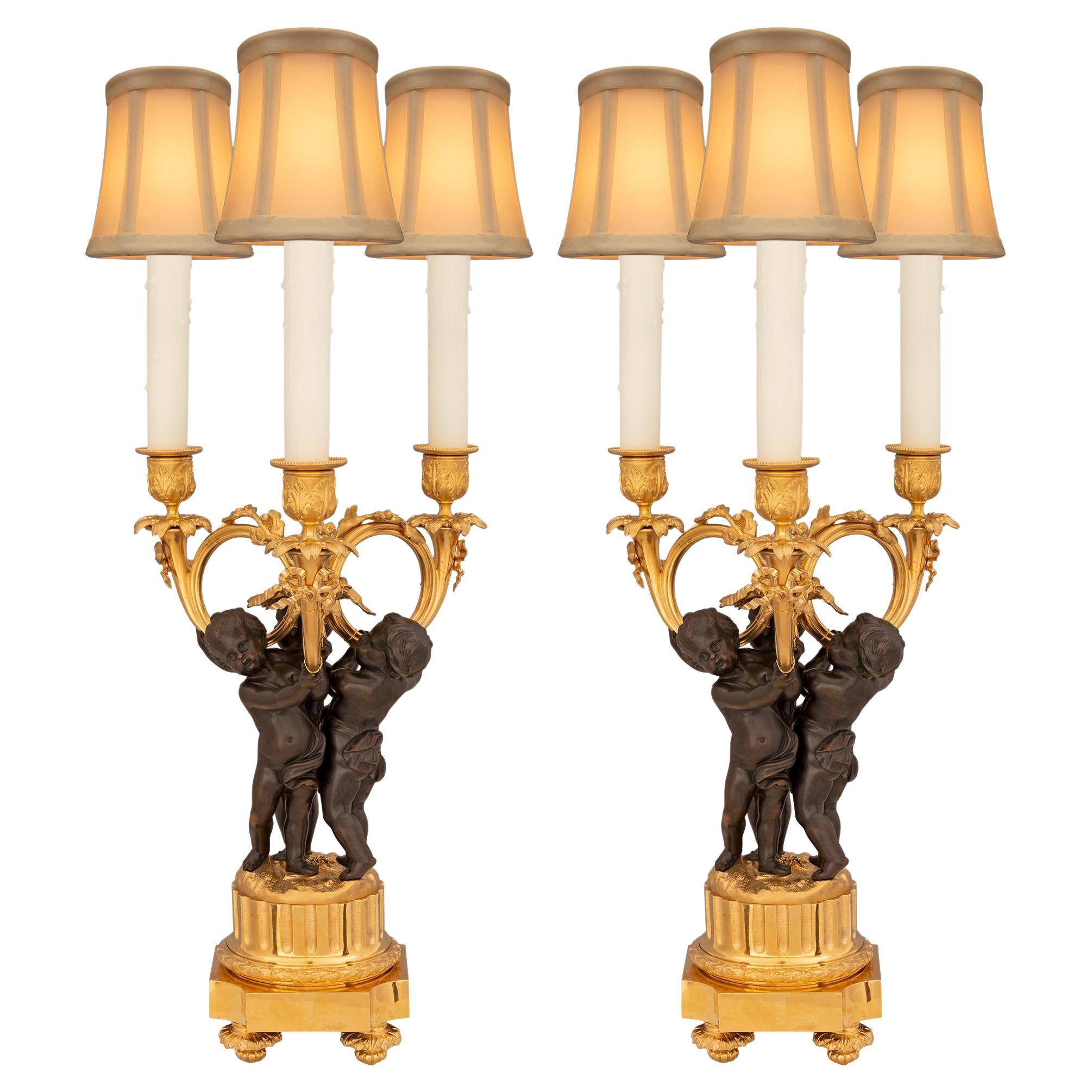 Paire de lampes de style Louis XVI du 19ème siècle en bronze patiné et bronze doré