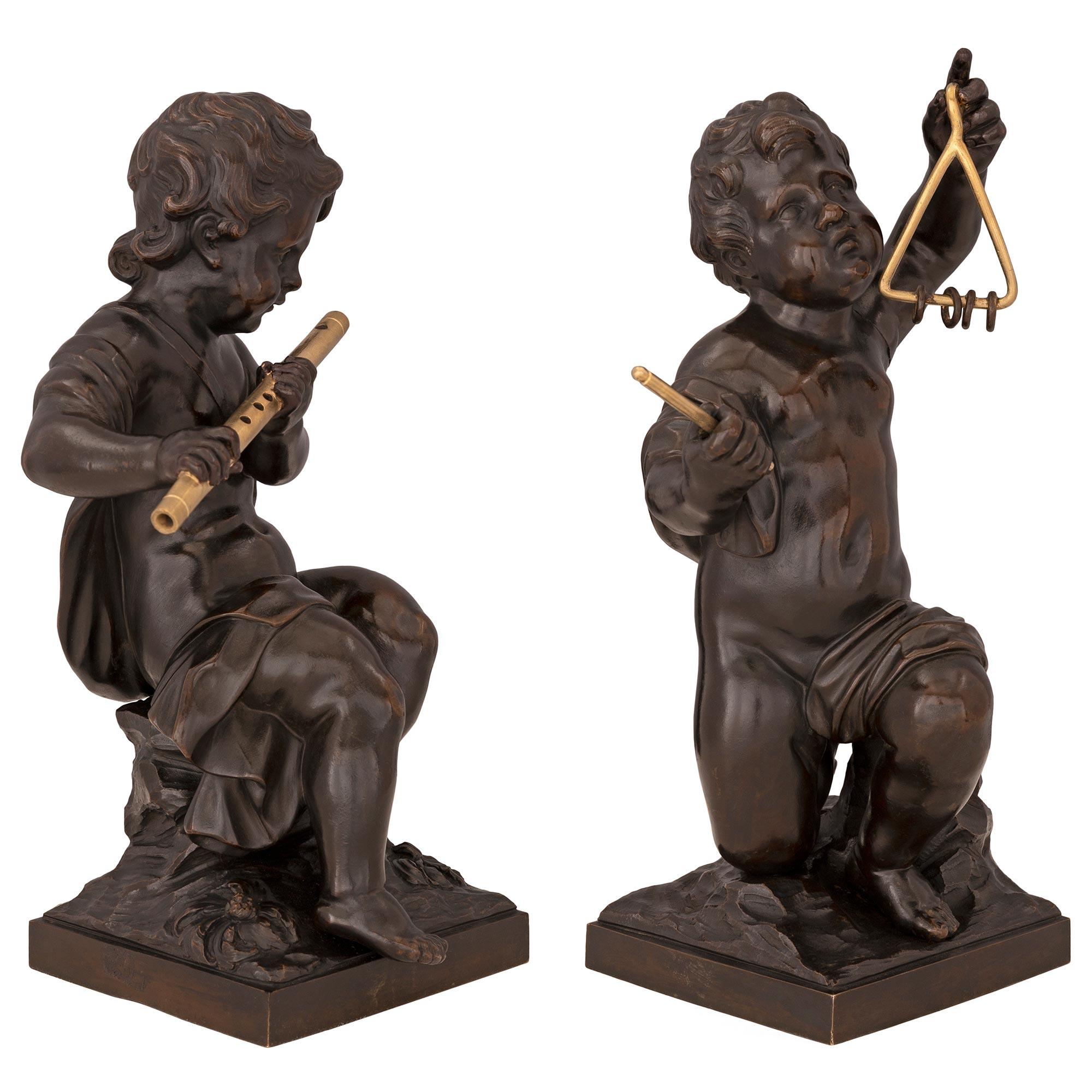 A charming and high quality pair of French 19th century Louis XVI st. patinated bronze and ormolu statues. Each statue is raised by a square base with a Fine ground like design. Above are the charming richly chased cherubs, one kneeling and the