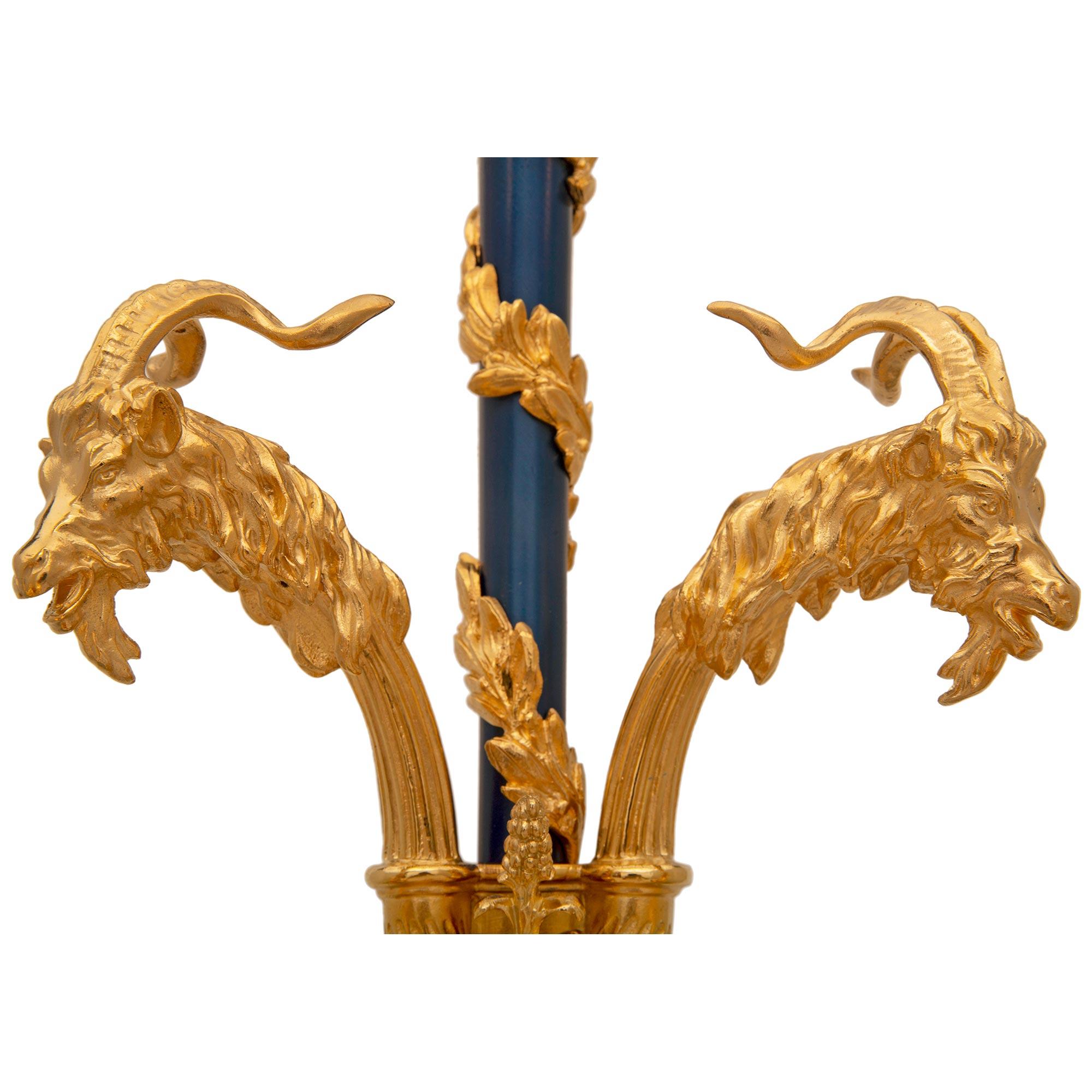 A striking and very unique pair of French 19th century Louis XVI st. enameled bronze and ormolu sconces after a model by Pierre Gouthière. Each two arm sconce is centered by a beautiful bottom acorn finial with acanthus leaves below the extremely