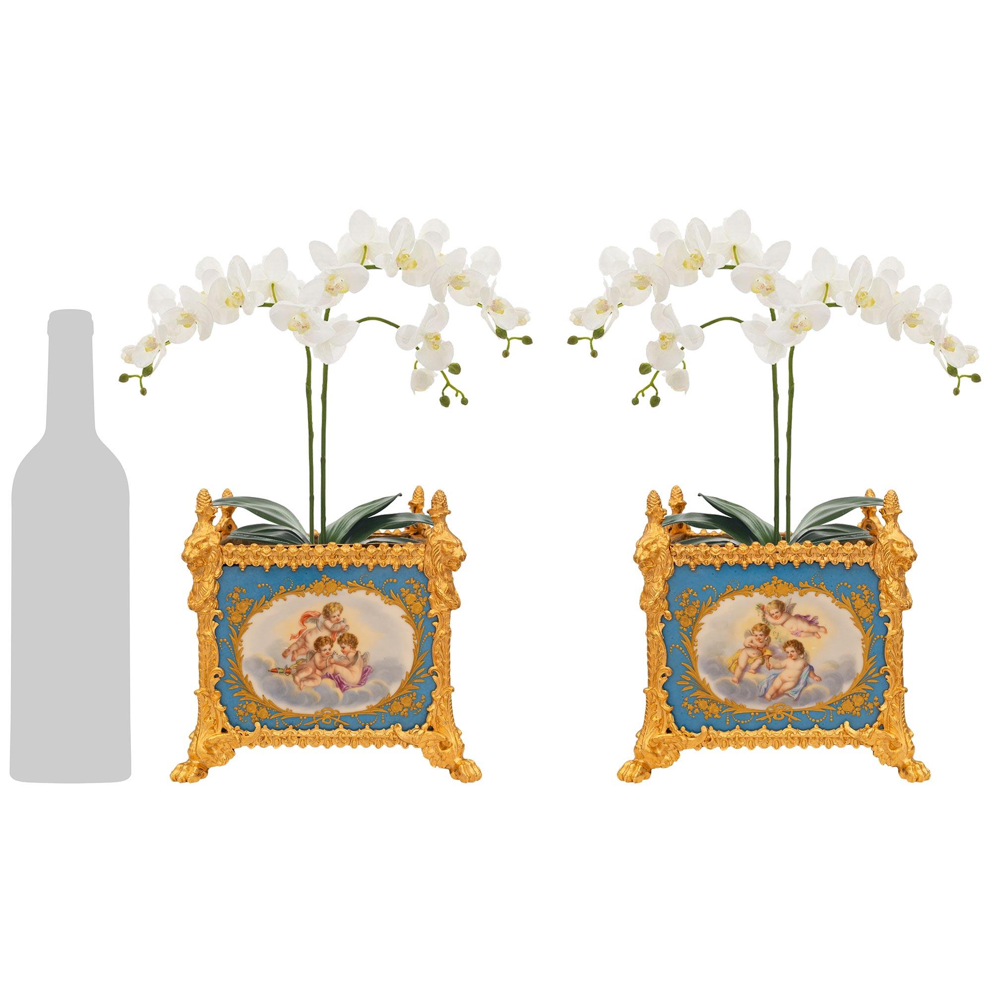 Una coppia elegante e di alta qualità di fioriere Jardinière in porcellana e ormolu di Sèvres del XIX secolo. Questa sorprendente coppia di fioriere quadrate è sollevata da piedini a zampa di Ormolu con disegni di foglie d'acanto su larga scala. Gli