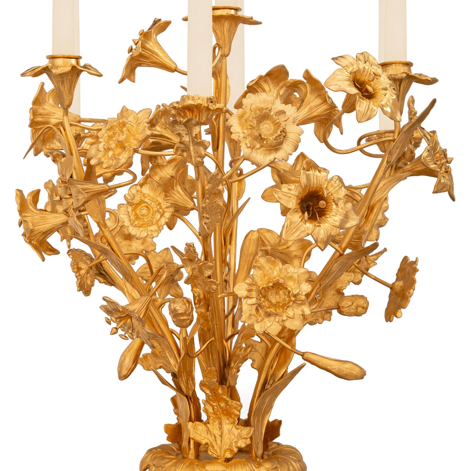 An impressive and large scale pair of French 19th century Louis XVI st. Sèvres Porcelain and Ormolu candelabras. The richly decorated pair of seven arm candelabras are supported by four beautiful “C” scrolled acanthus leaf supports flanked by