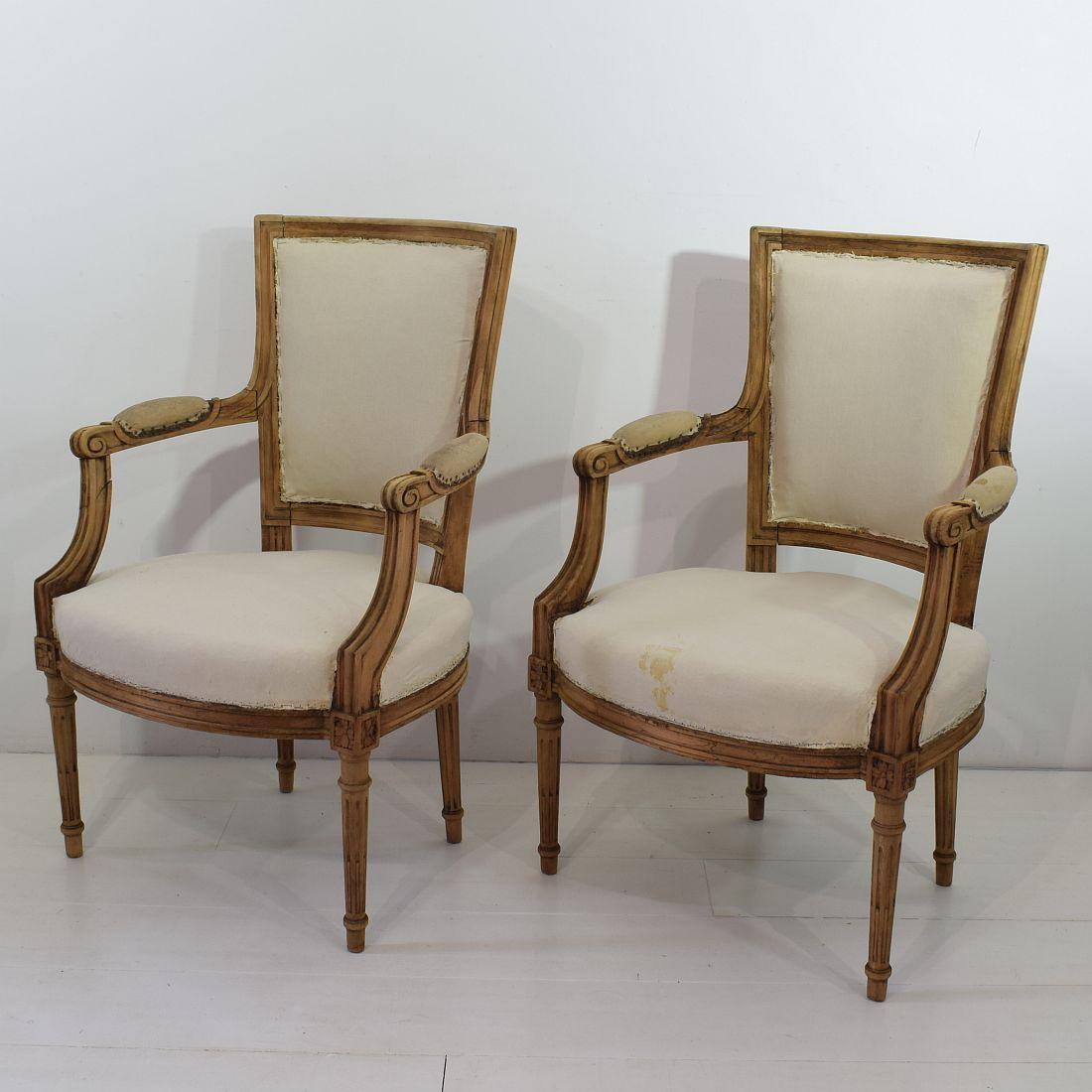 Beautiful pair of Louis XVI style armchairs, France, circa 1850, in beautiful weathered and fair structural condition. Old repairs.
They need new lining. Measures: Seat height is 41 cm. More pictures available on request.